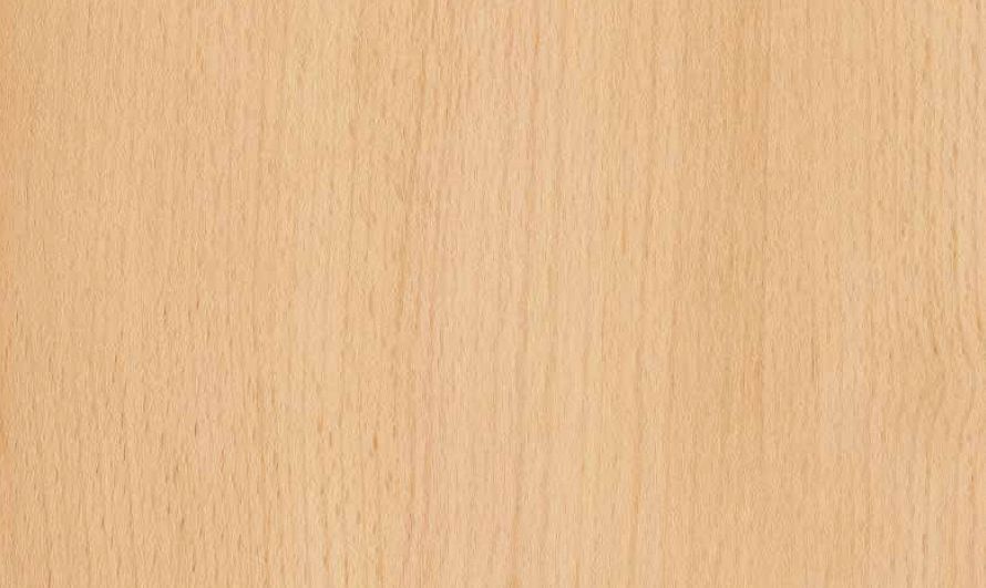A close-up view of light-colored, smooth wood grain texture with vertical patterns.