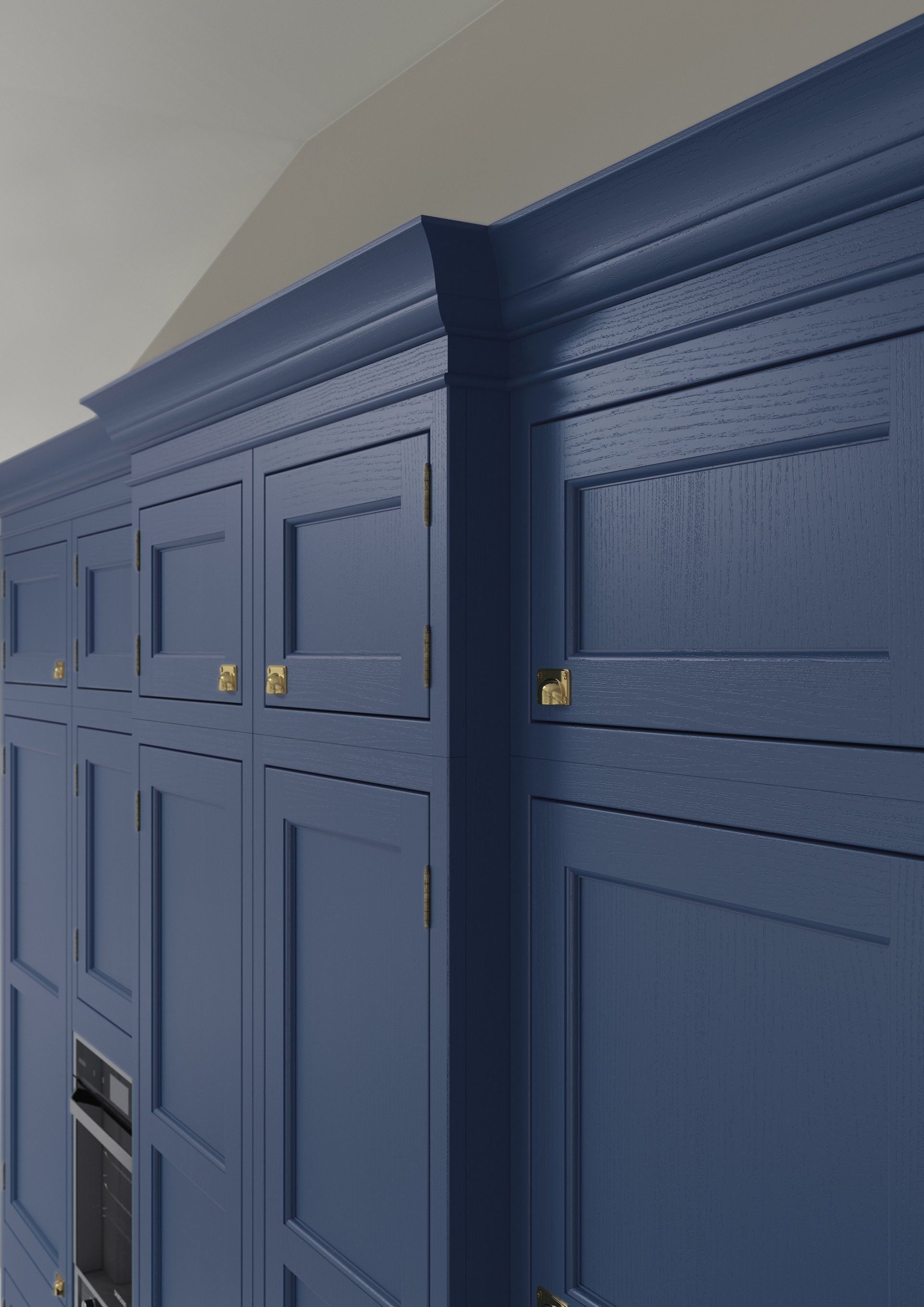 Deep blue shaker-style kitchen cabinetry with crown molding and gold circular knobs.