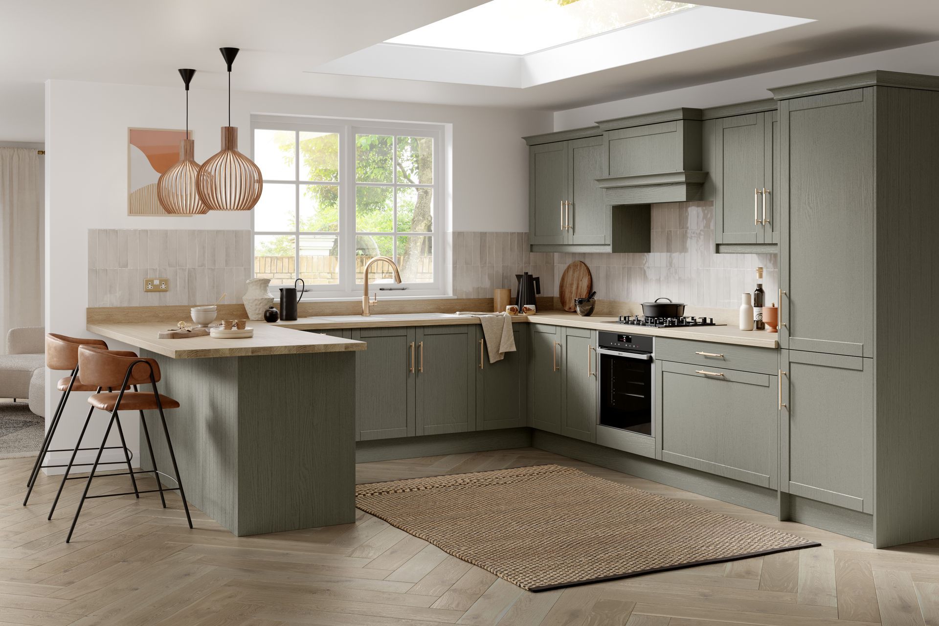 Modern kitchen with sage green cabinets, light wood flooring, a breakfast bar with two stools, and a textured area rug.