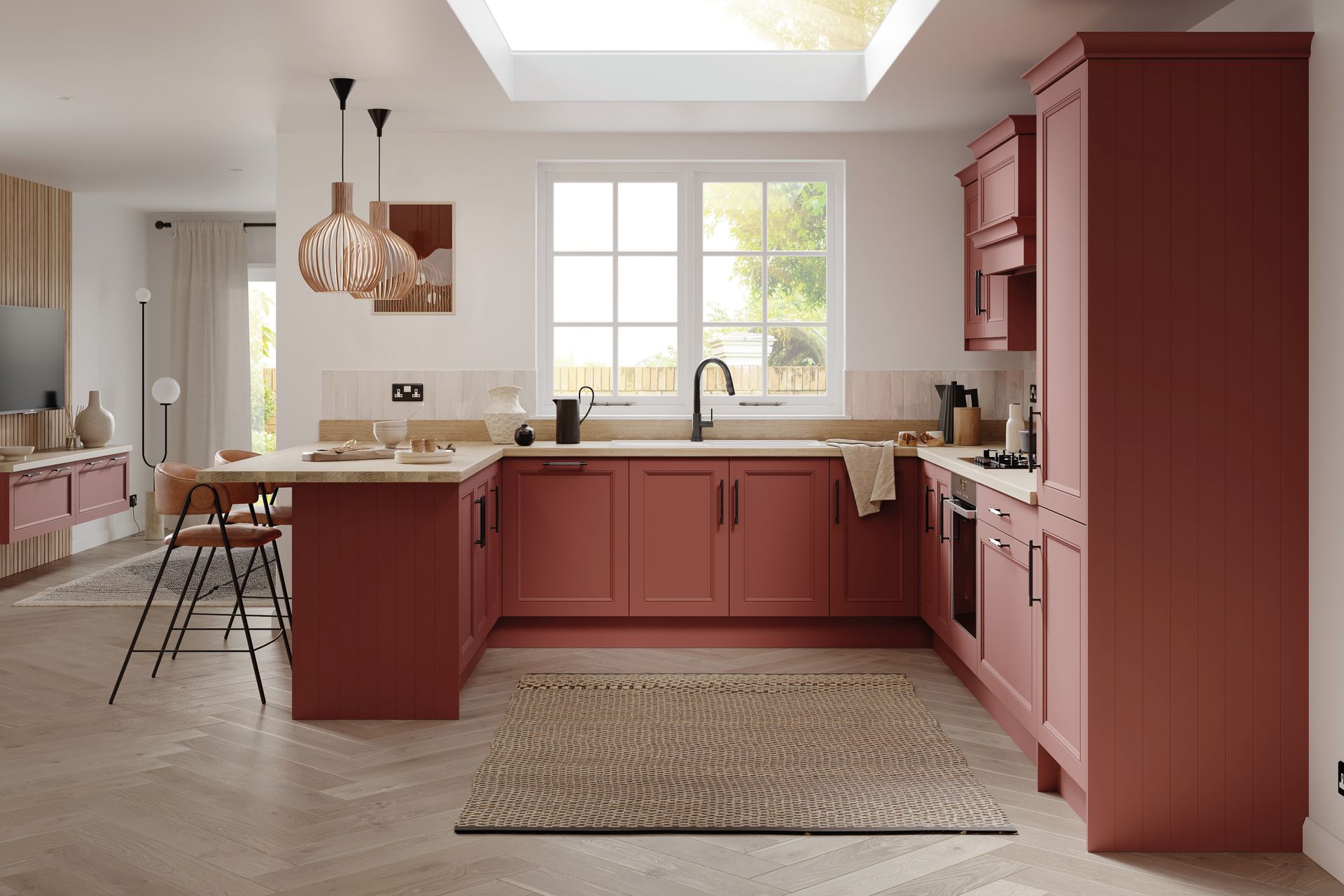 A modern kitchen with terracotta-colored cabinets, a central island with bar stools, and a herringbone wood floor.