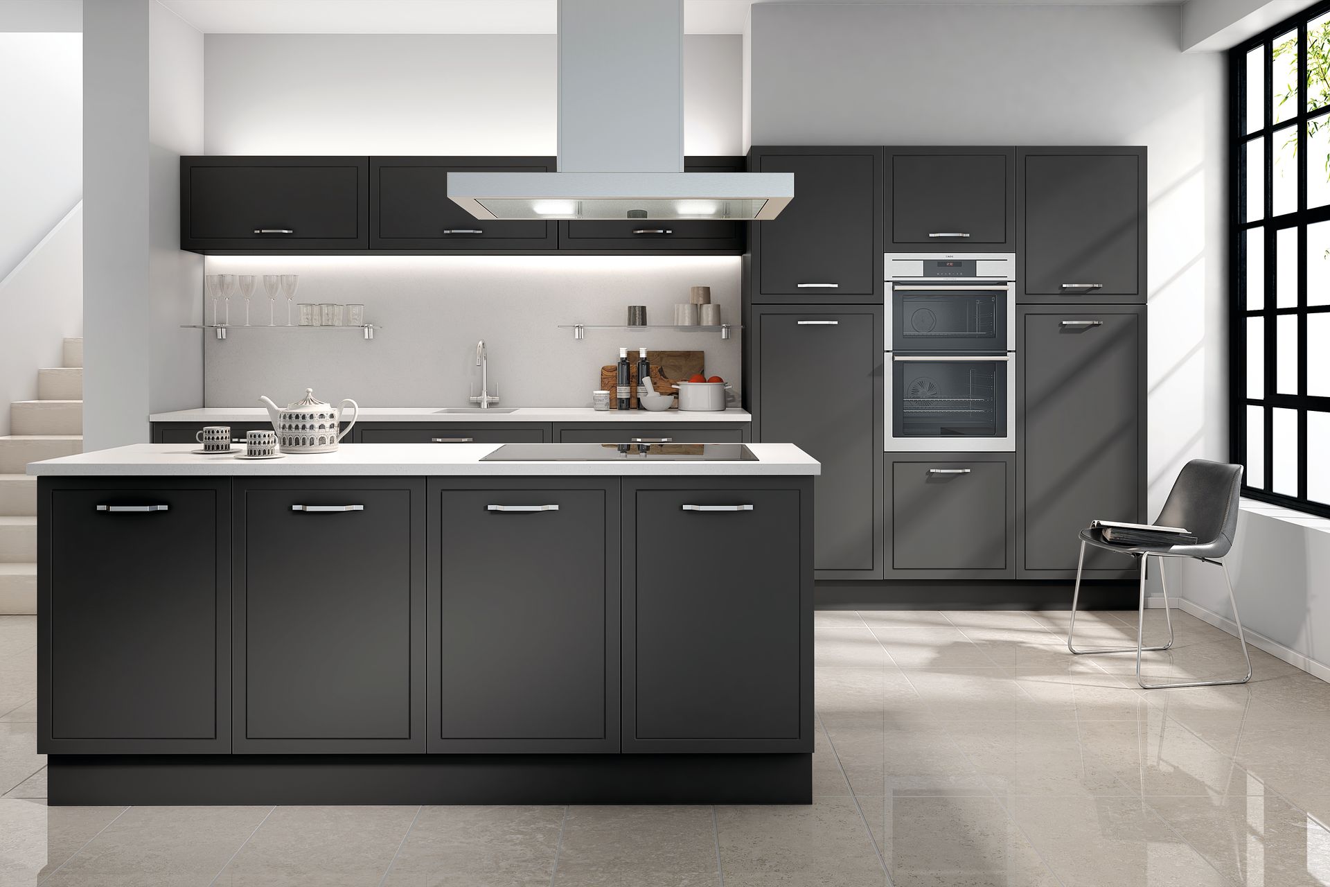 Modern kitchen with matte dark grey cabinets, a white countertop island, integrated double oven, and tiled flooring.