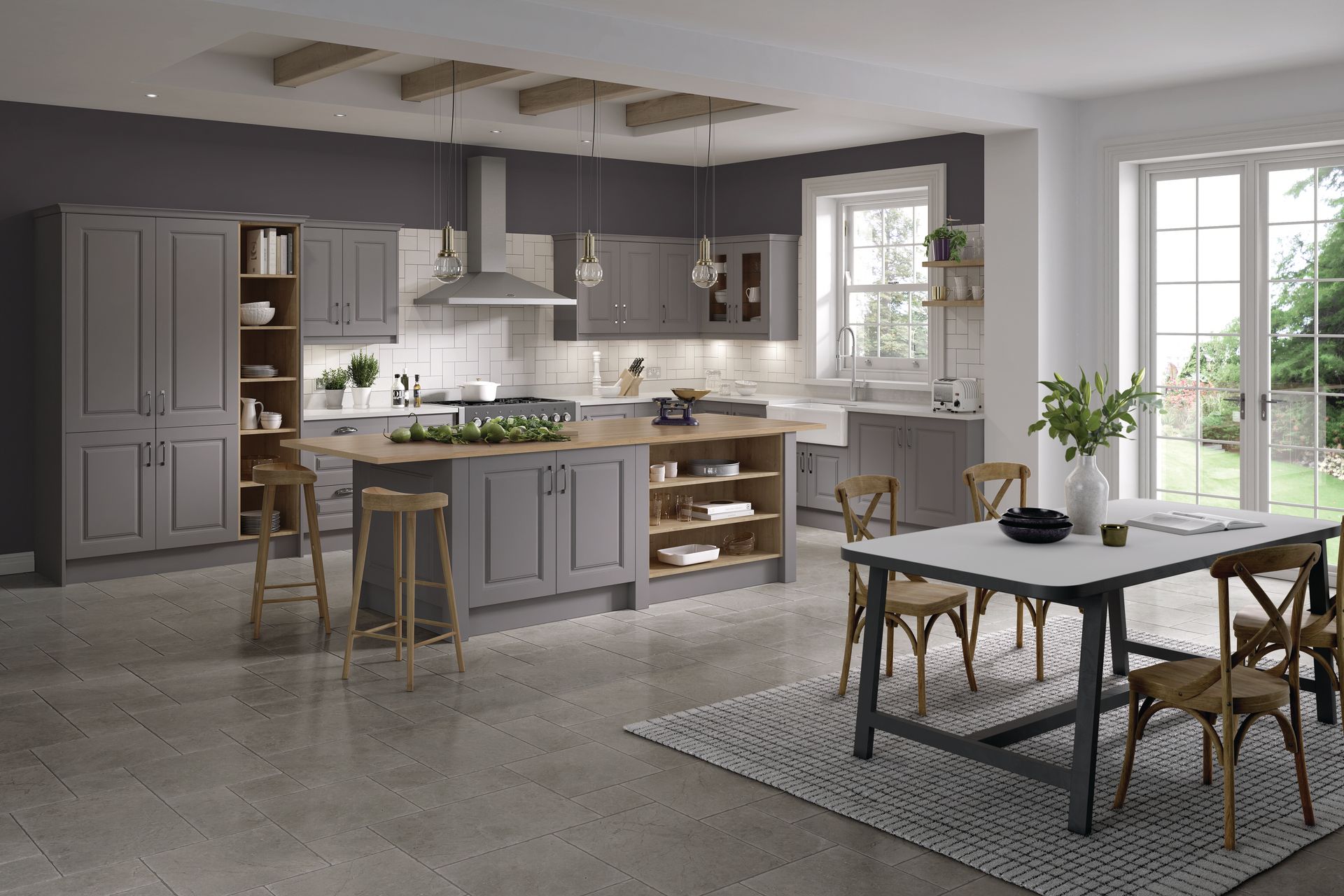 A modern gray kitchen with a wooden island, breakfast bar stools, and a dining table on a patterned rug.