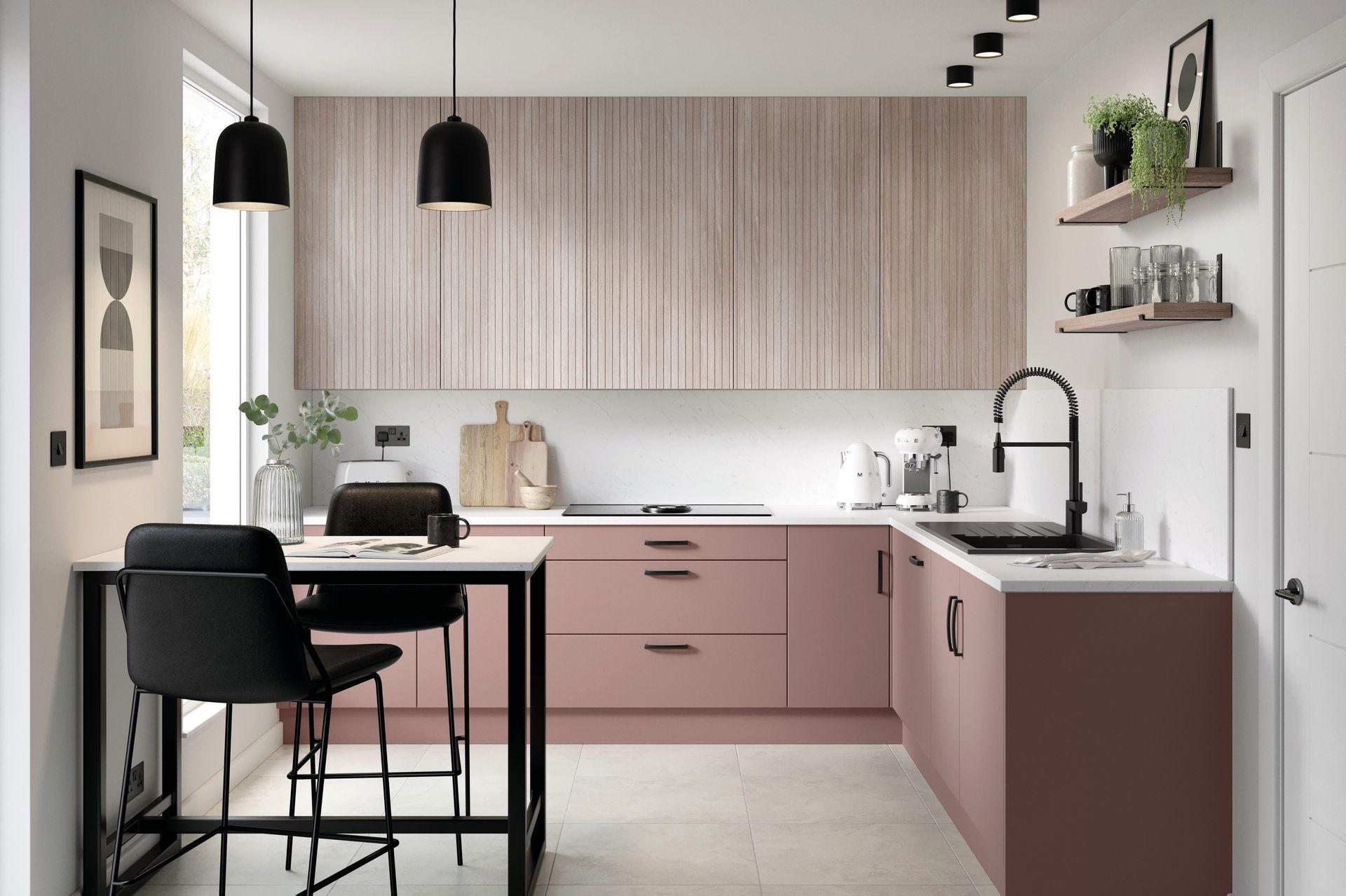 A modern kitchen with muted pink lower cabinets, wood-grain upper cabinets, a dining table with two stools, and decor.