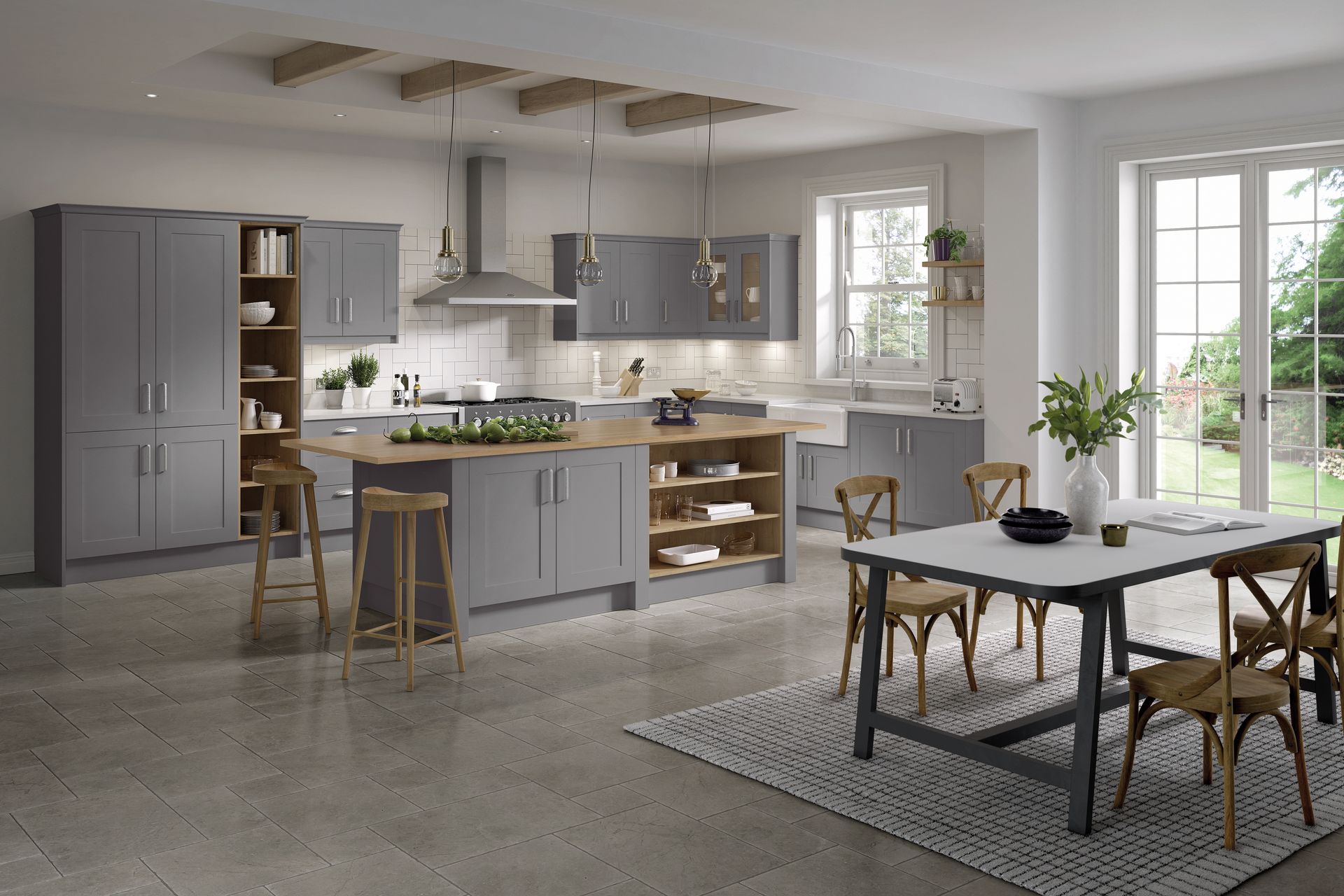 Modern kitchen with grey cabinets, a central island with wood countertop, and a dining table on a patterned area rug.