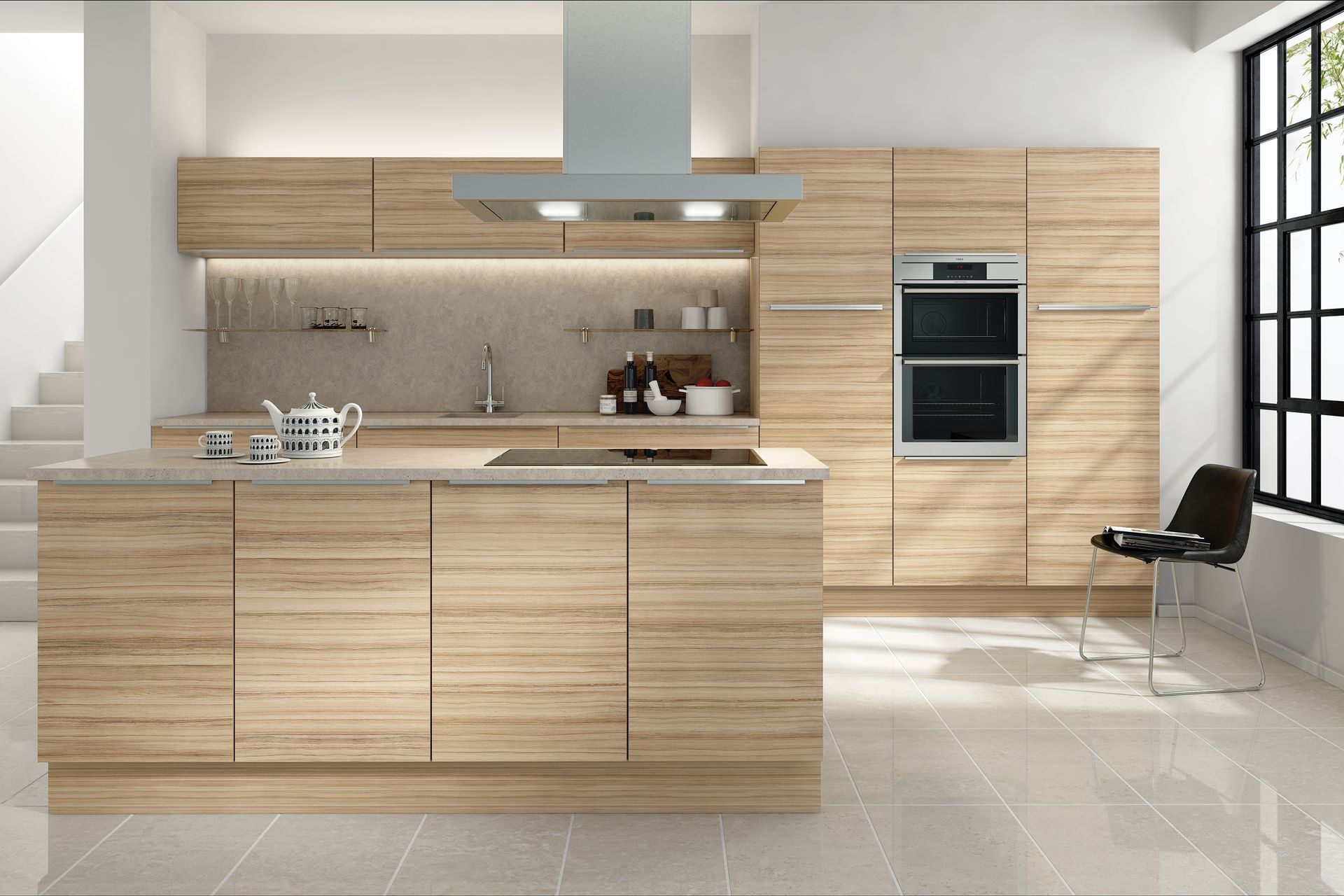 A modern kitchen features light wood cabinets, a central island with a stove, a built-in oven, and a single black chair.