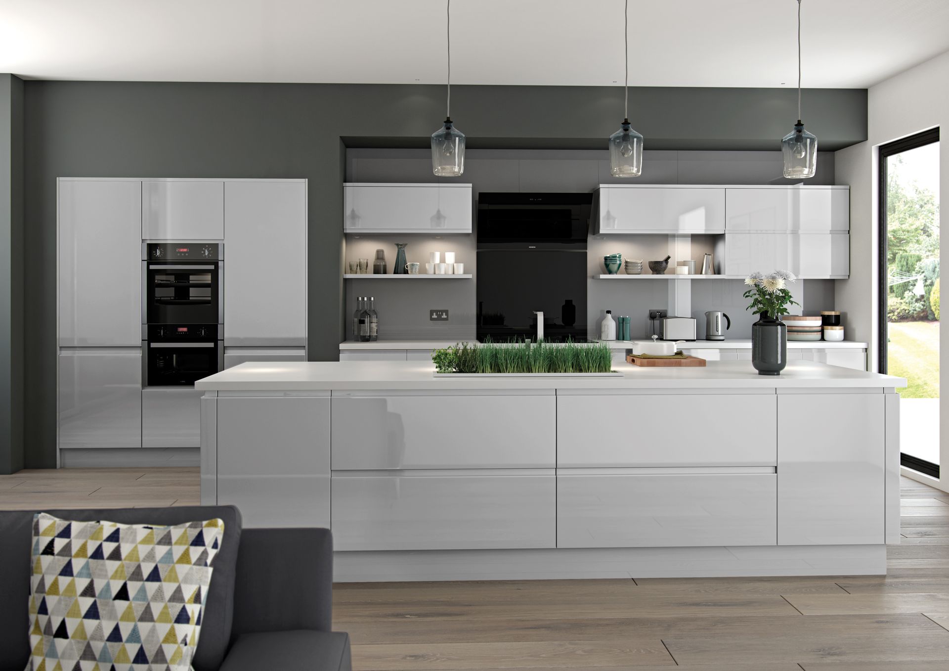 A modern kitchen featuring glossy white cabinets, a large central island, gray accent walls, and three pendant lights.