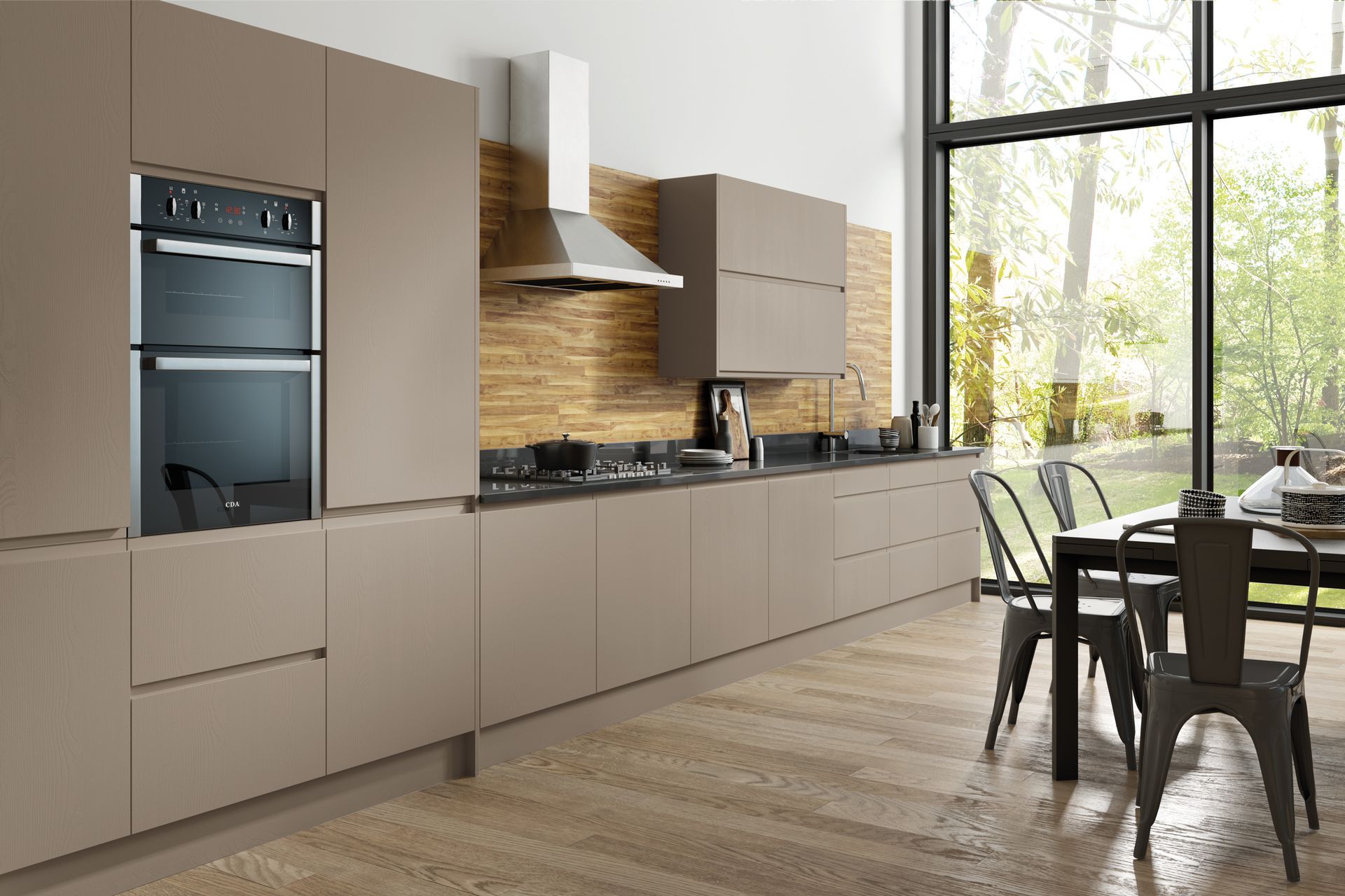 A modern kitchen with matte taupe cabinets, a wood-grain backsplash, a double wall oven, and a dining table with chairs.