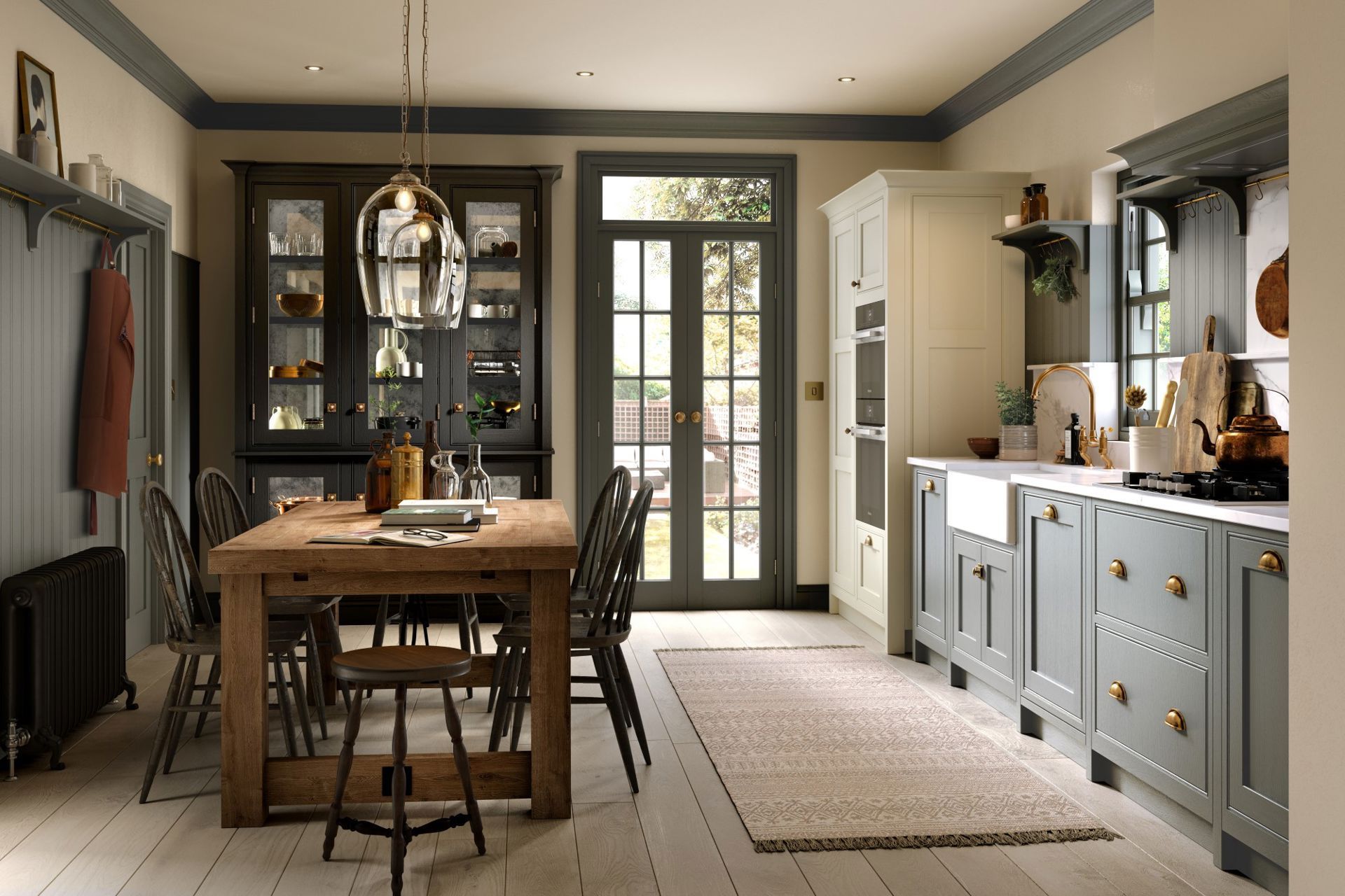 A kitchen featuring a wooden dining table, blue-gray cabinets, and light wood flooring, illuminated by a glass pendant.