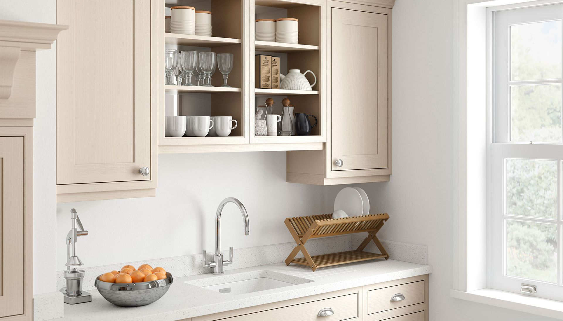 A light-colored kitchen interior features a window, wooden cabinets, a sink with a metal faucet, and a bowl of fruit.