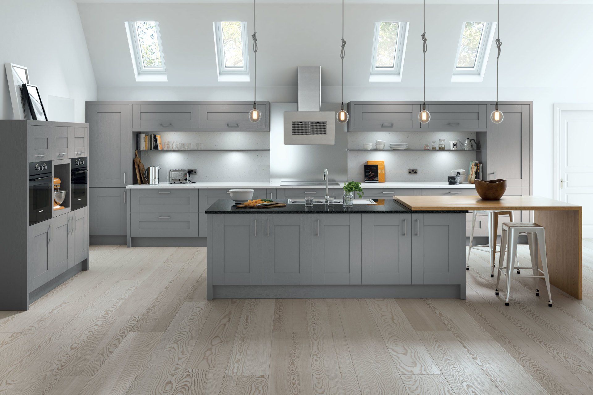 A modern kitchen with grey shaker-style cabinets, a central island with a wooden breakfast bar, and light wood flooring.