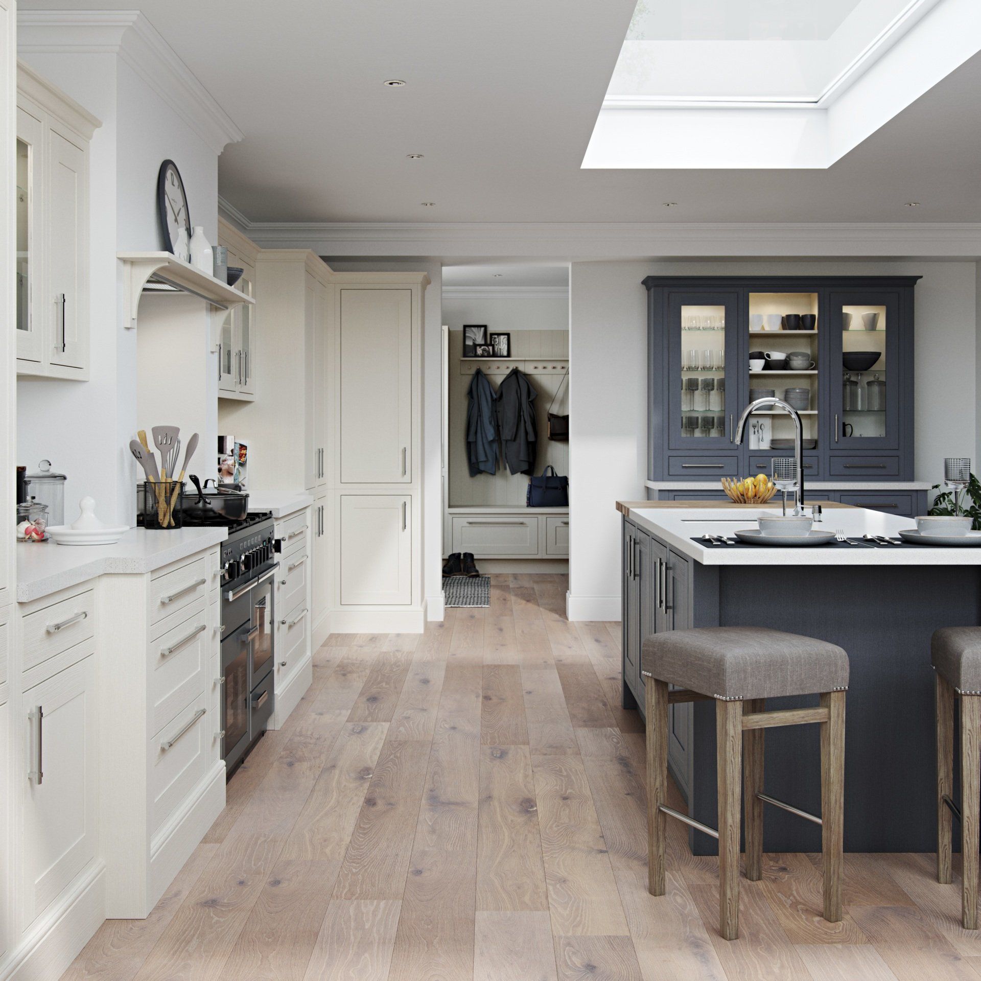 A bright kitchen with white cabinets, a dark blue island with stools, a gas range, and a skylight above.