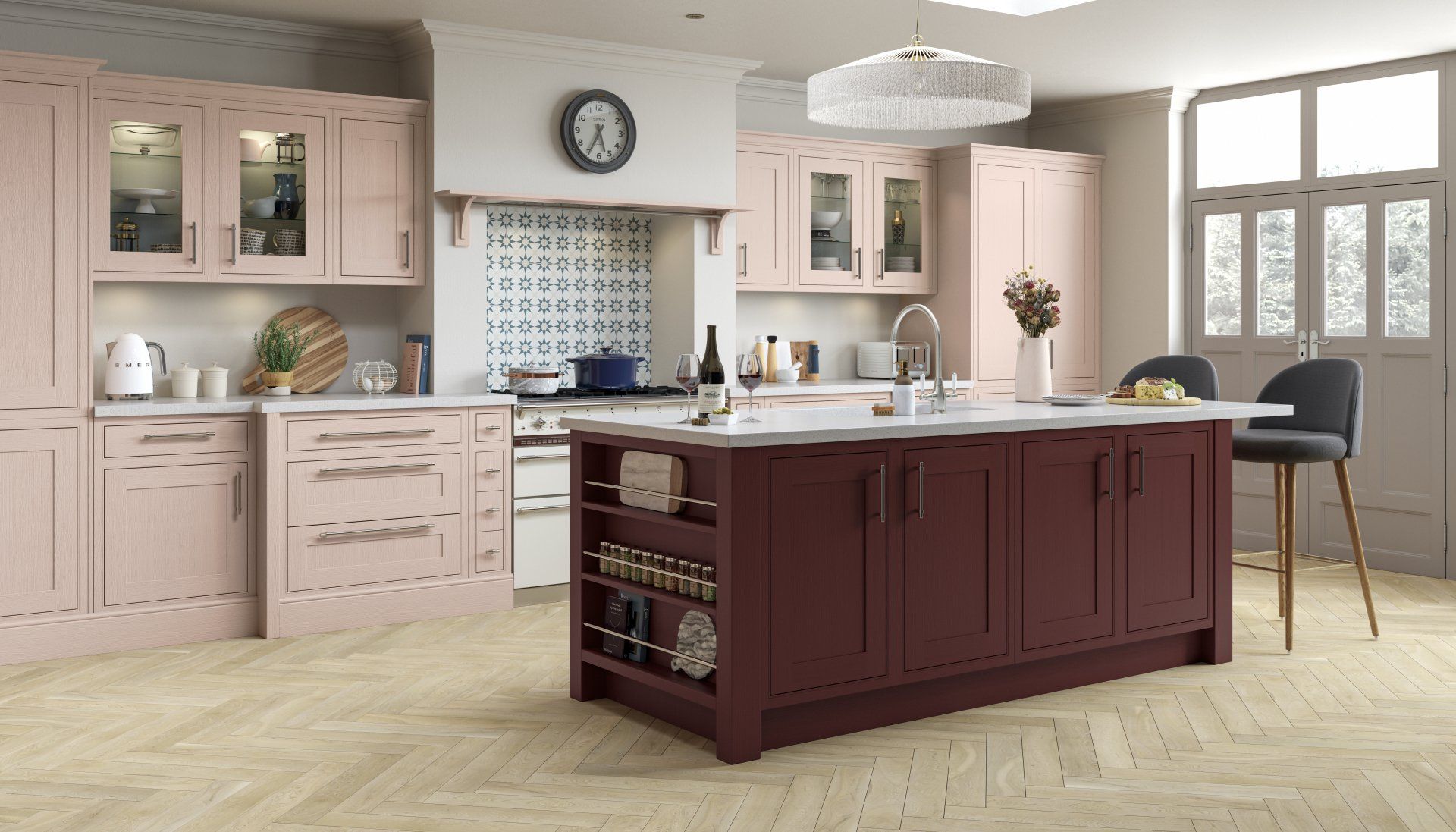A kitchen featuring pale pink cabinets, a deep burgundy kitchen island with shelving, and light wood herringbone flooring.