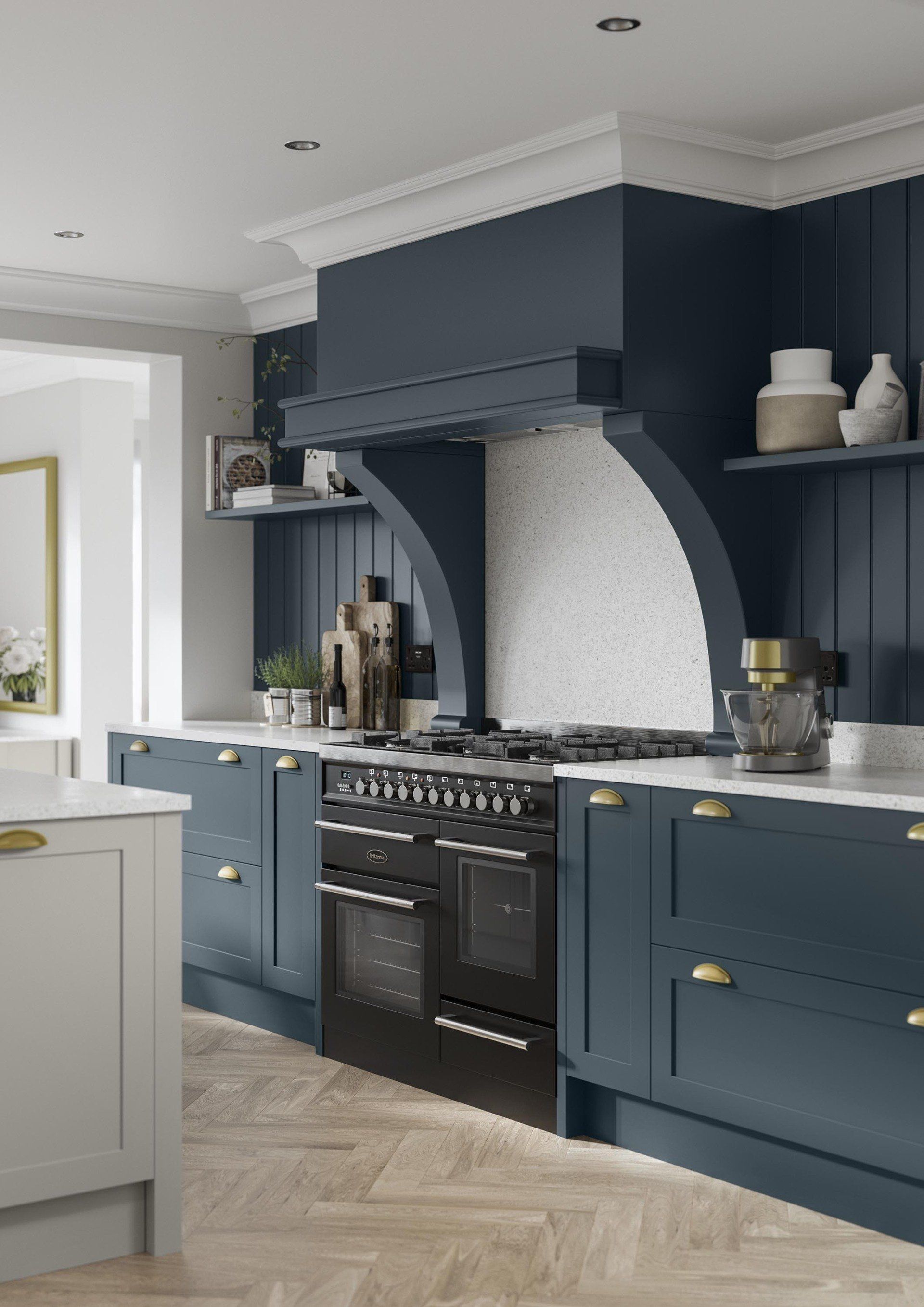 A modern kitchen featuring navy blue cabinets, a black range stove, a white backsplash, and light wood herringbone flooring.