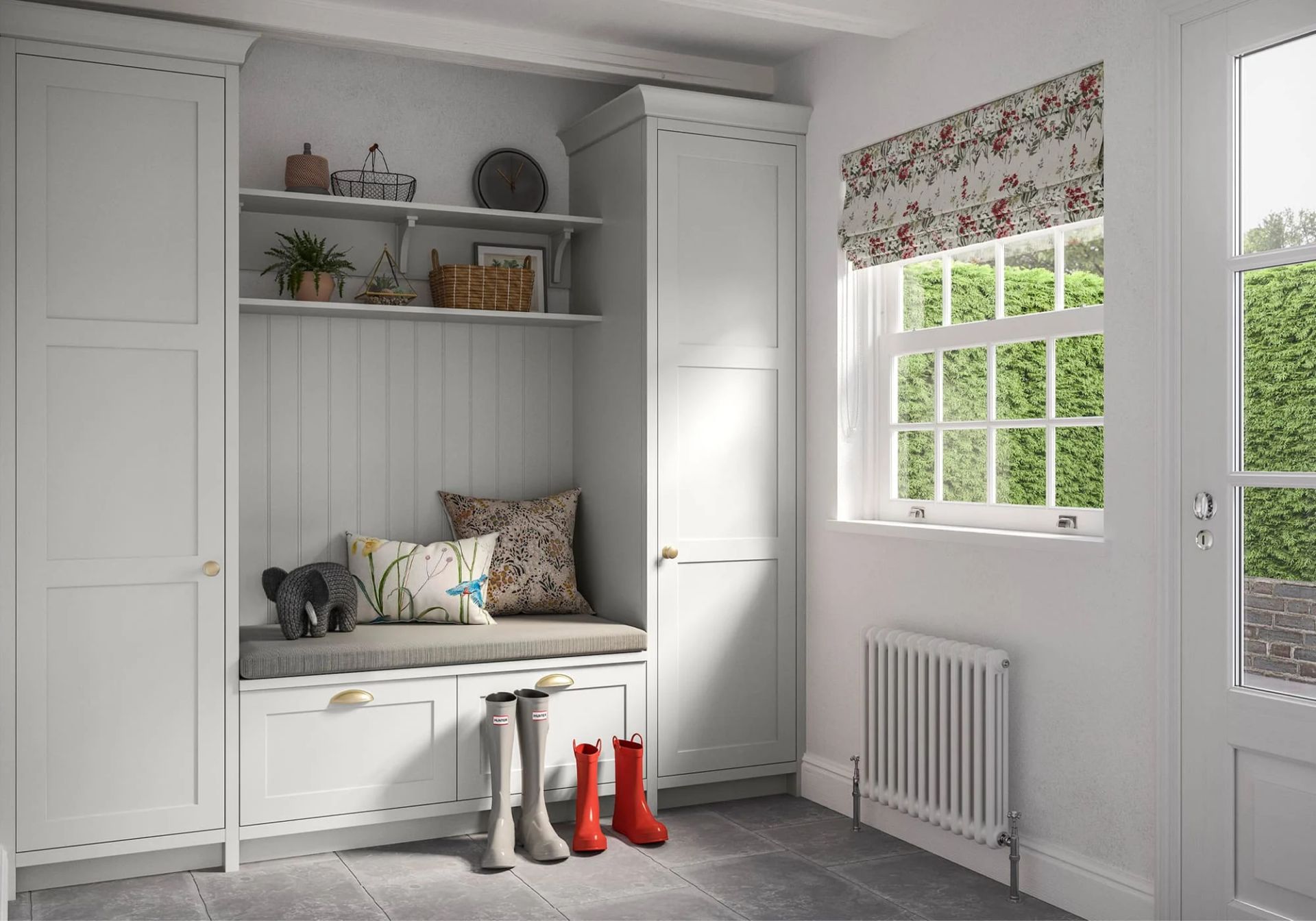 A white mudroom featuring a bench, built-in storage cabinets, a wall-mounted shelf, and a radiator by a window.