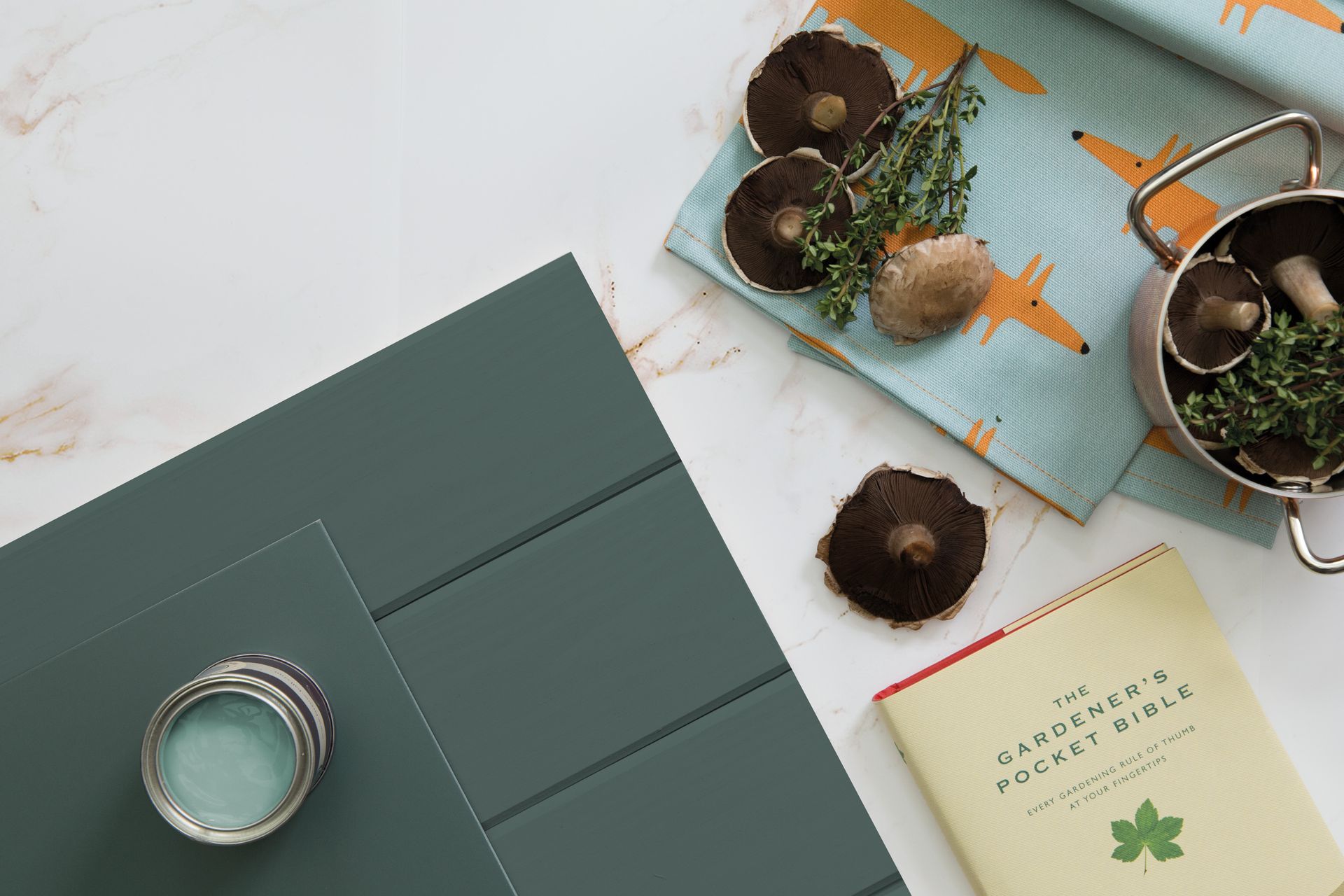 A top-down view of mushrooms, a small metal pot, a
