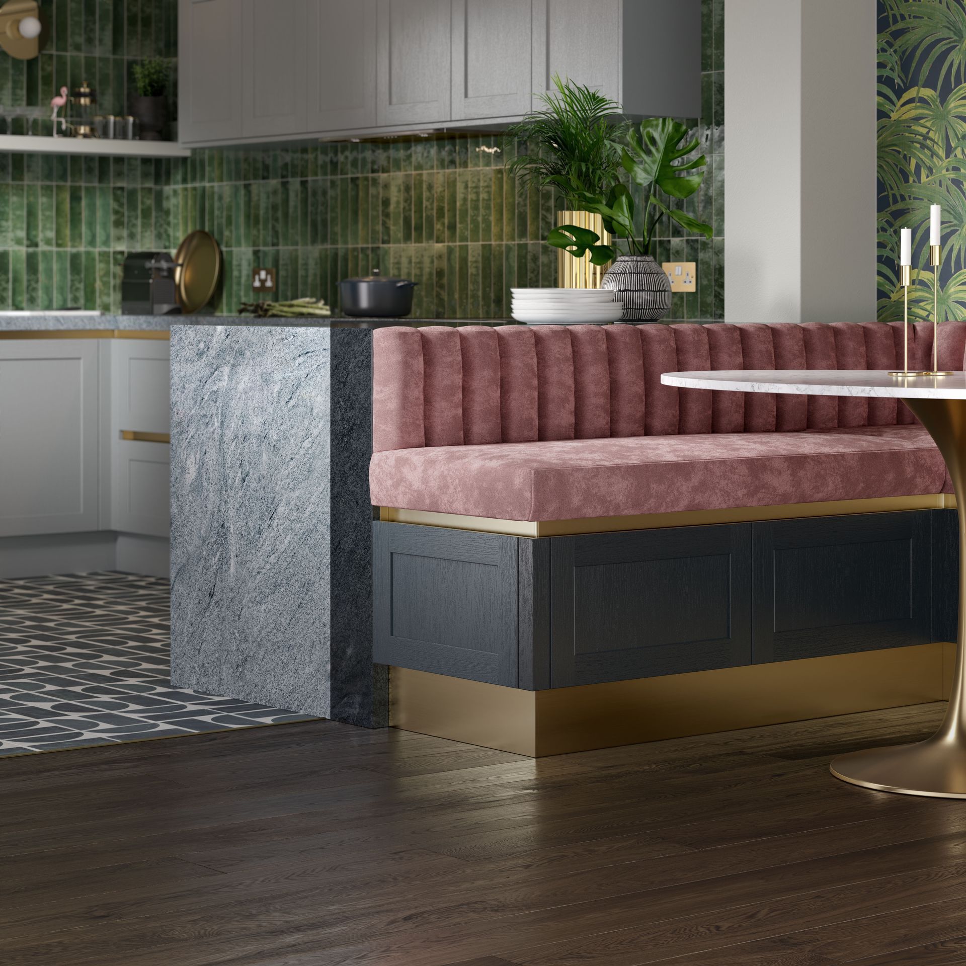 A plush pink velvet tufted booth with a dark base and gold trim sits next to a grey marble kitchen island.
