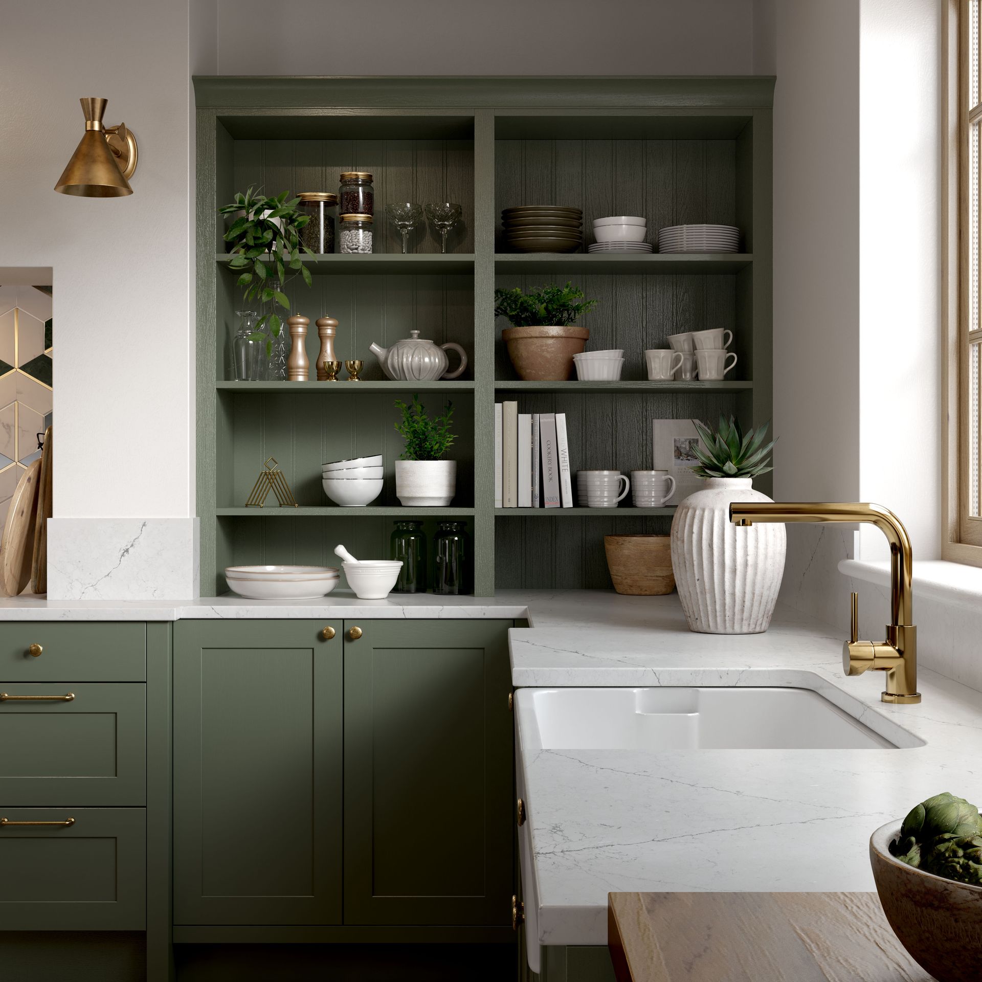A kitchen with olive green cabinets, open shelving, marble countertops, a white sink, and gold hardware.