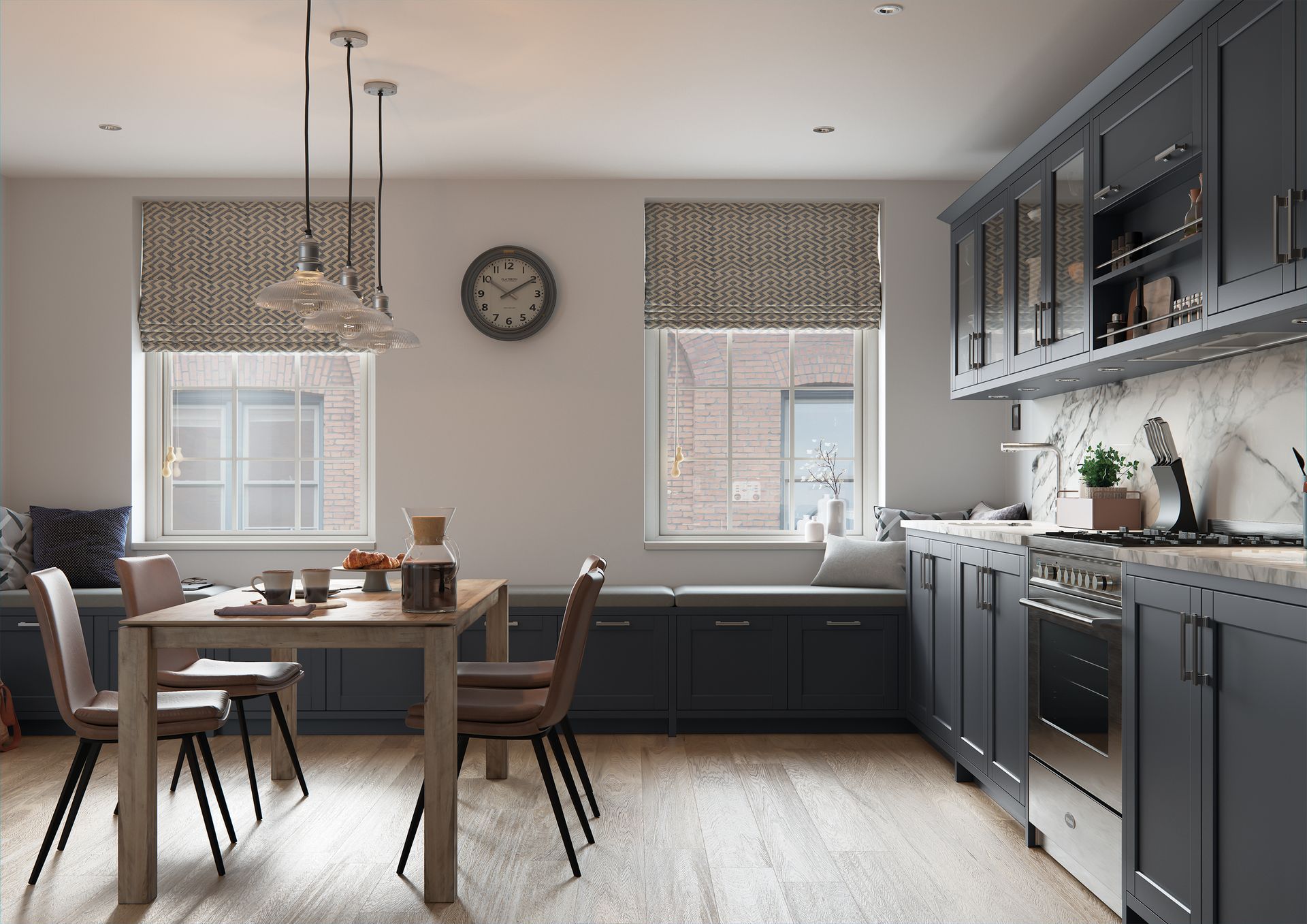 A modern kitchen with dark blue cabinetry, light wood floors, a dining table, and built-in window seating.
