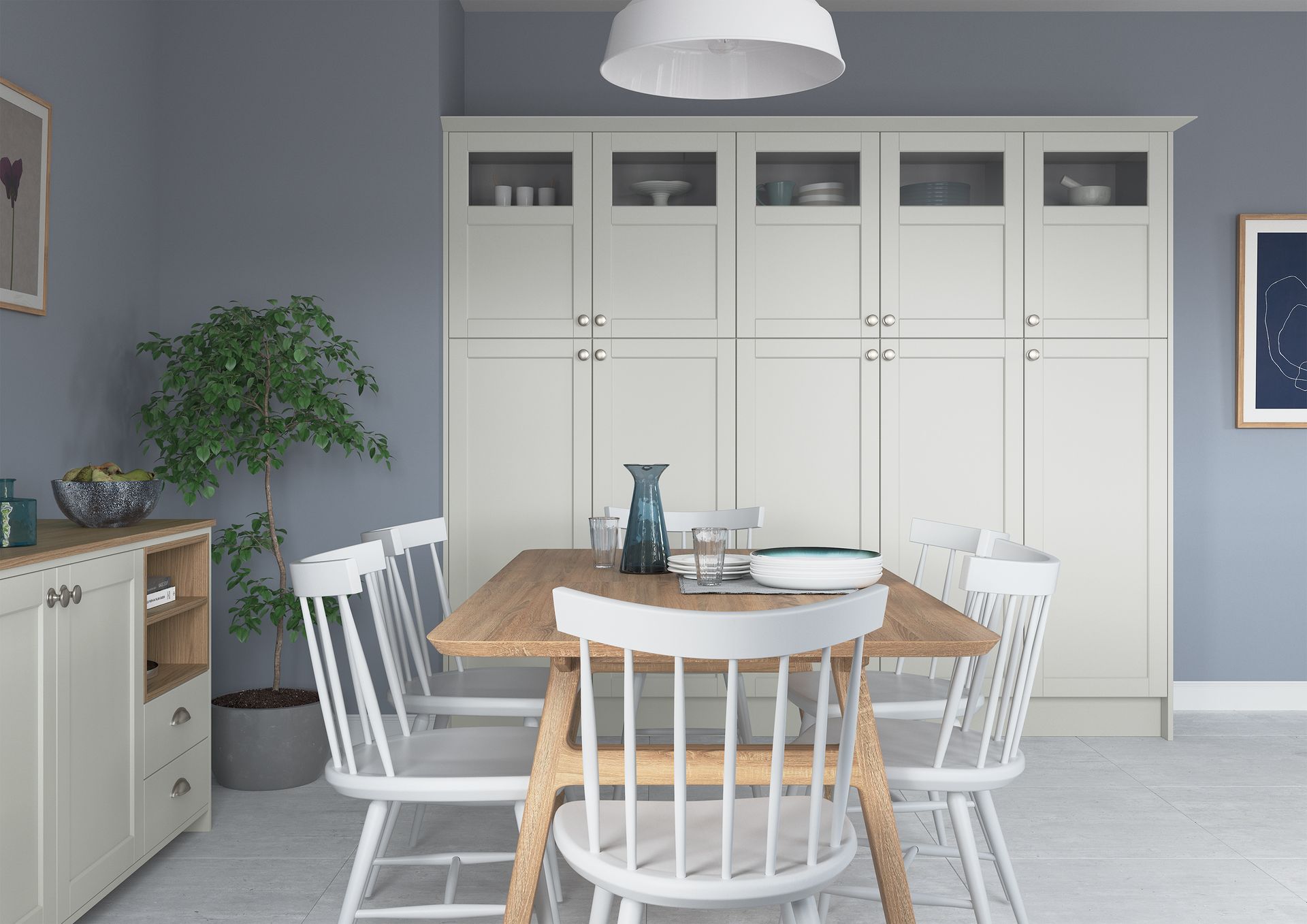 A light wood dining table with white chairs in front of a tall, light beige wall unit, set against grey walls.