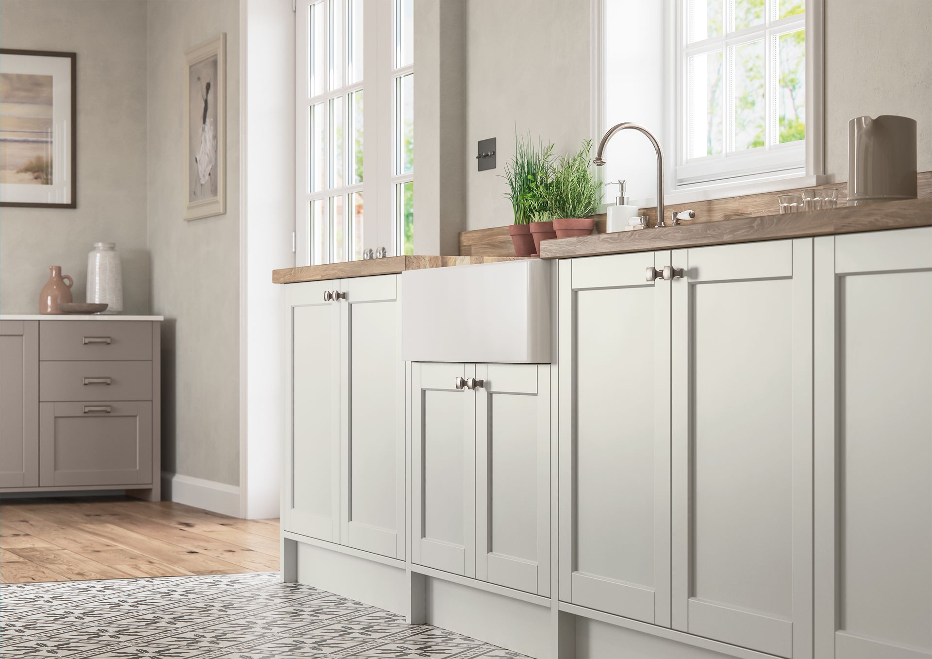 Light gray kitchen cabinets with shaker-style doors, a white farmhouse sink, and wooden countertops in a bright room.