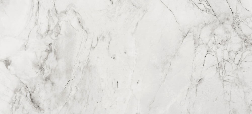 White marble surface with subtle, branching grey veins throughout.