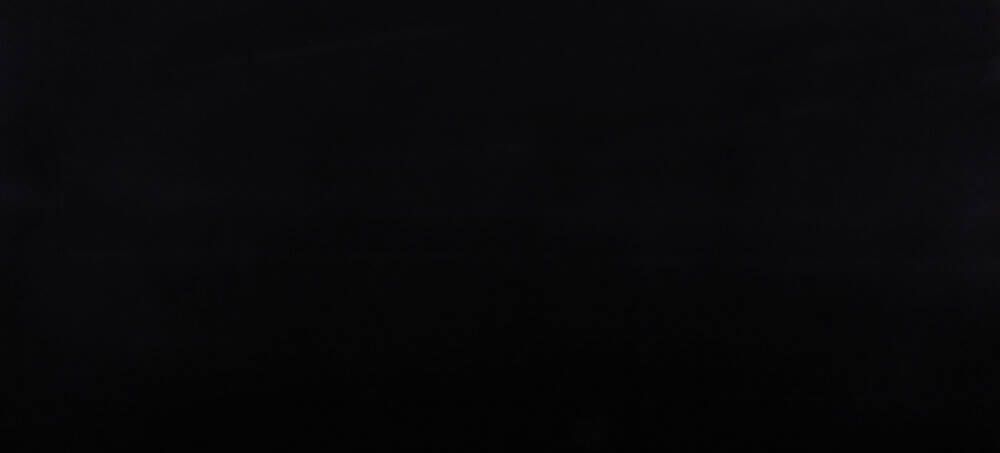 A dark, mostly black screen with faint, horizontal textured lines across the bottom.
