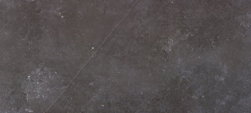 Dark grey stone-effect tile with a textured, matte surface and subtle light speckling.
