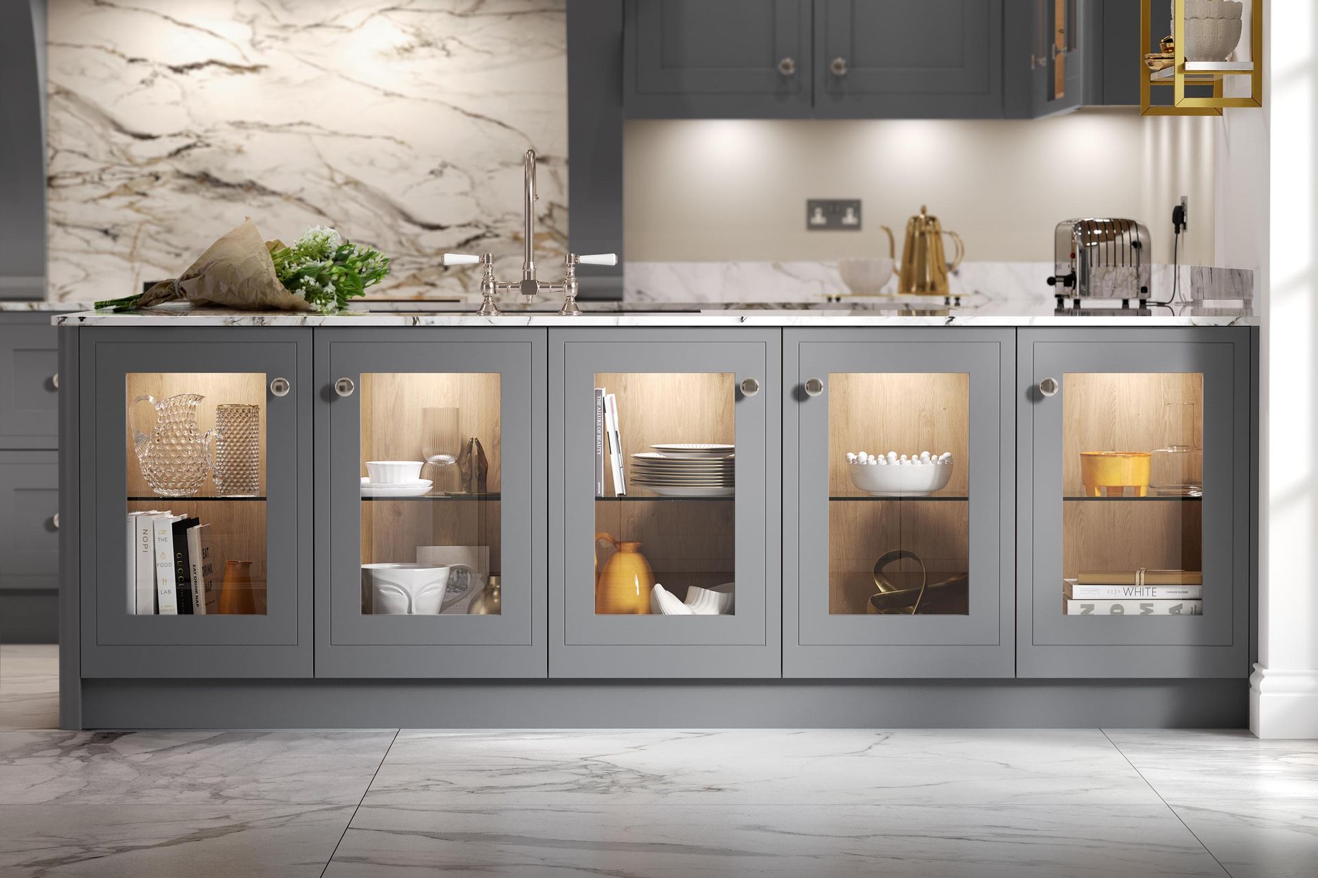 Modern kitchen with gray cabinets, marble backsplash, lit glass-front lower cabinets, and white countertops