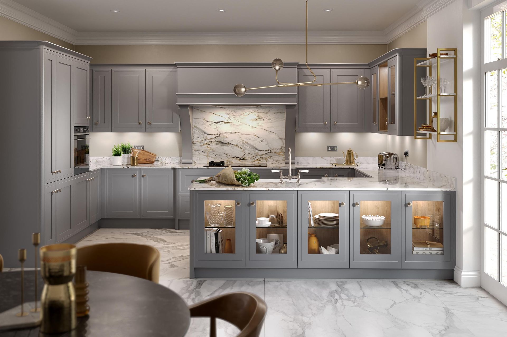 Modern gray U-shaped kitchen with marble countertops, an illuminated glass-front island, and warm under-cabinet lighting.
