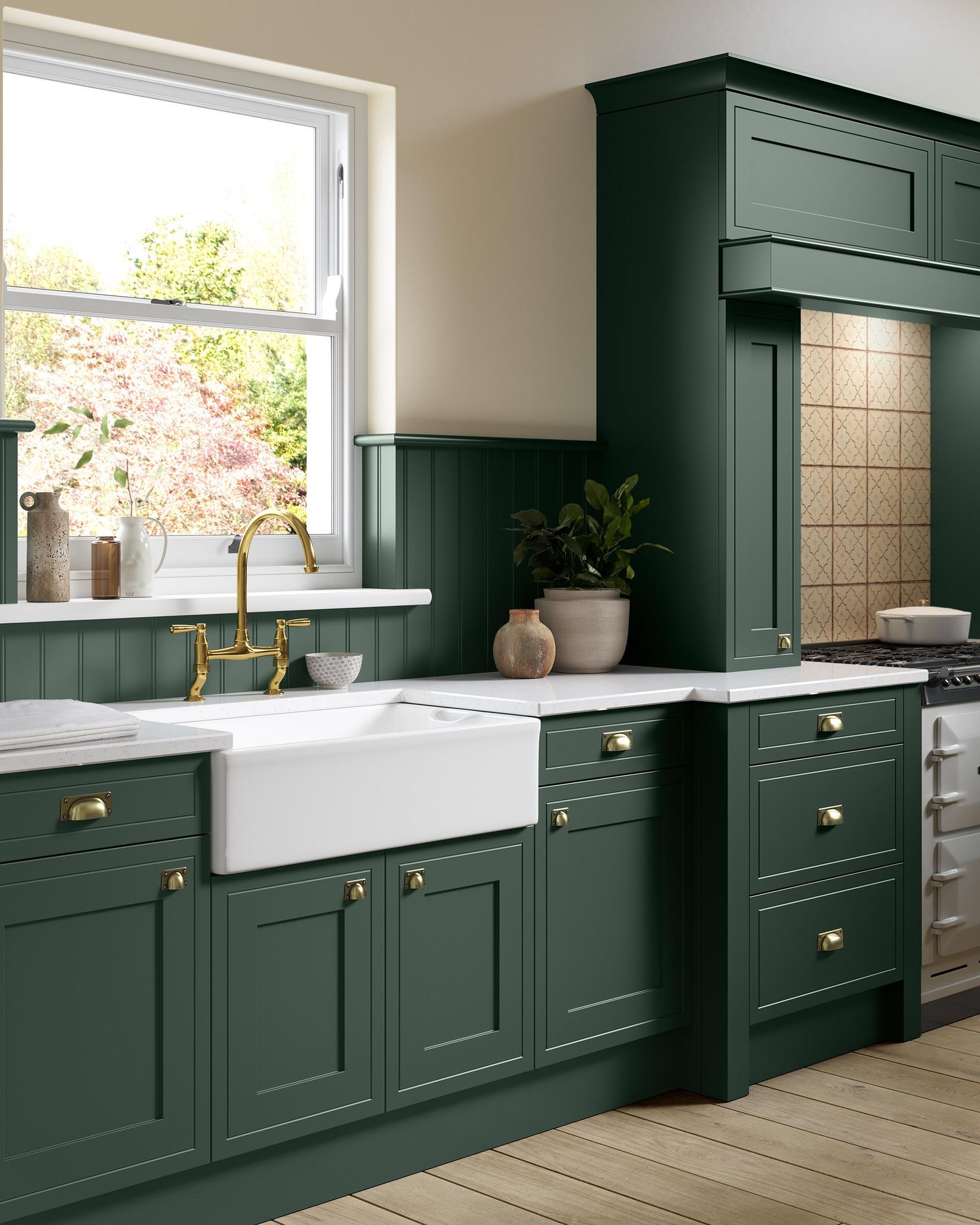 Dark green kitchen with white countertops, farmhouse sink, and a large window over the counter.