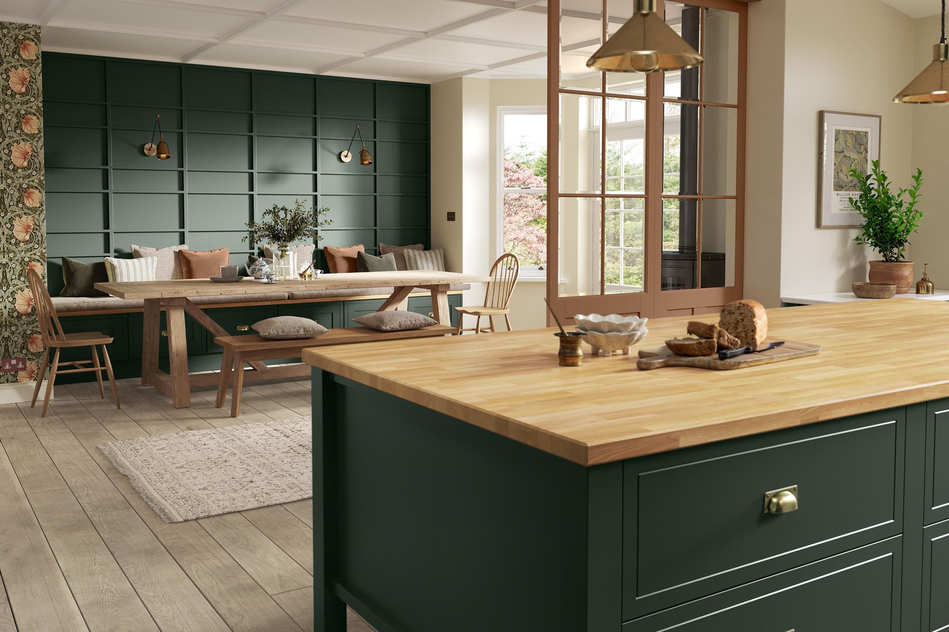 Modern kitchen with dark green island, wooden countertop, and cozy dining area by a window
