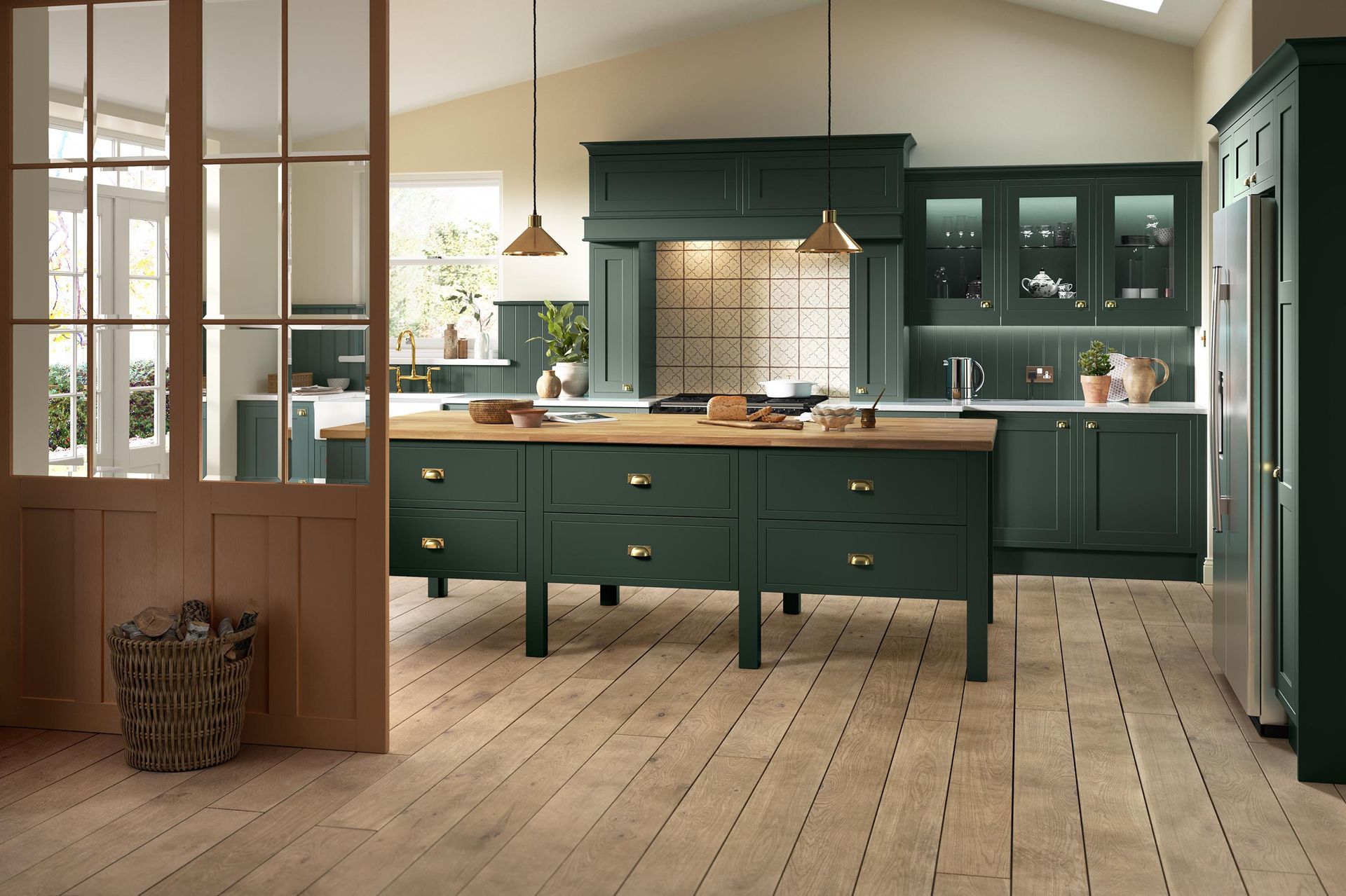 Modern kitchen with dark green cabinets, wood floor, island, and pendant lights by large windows