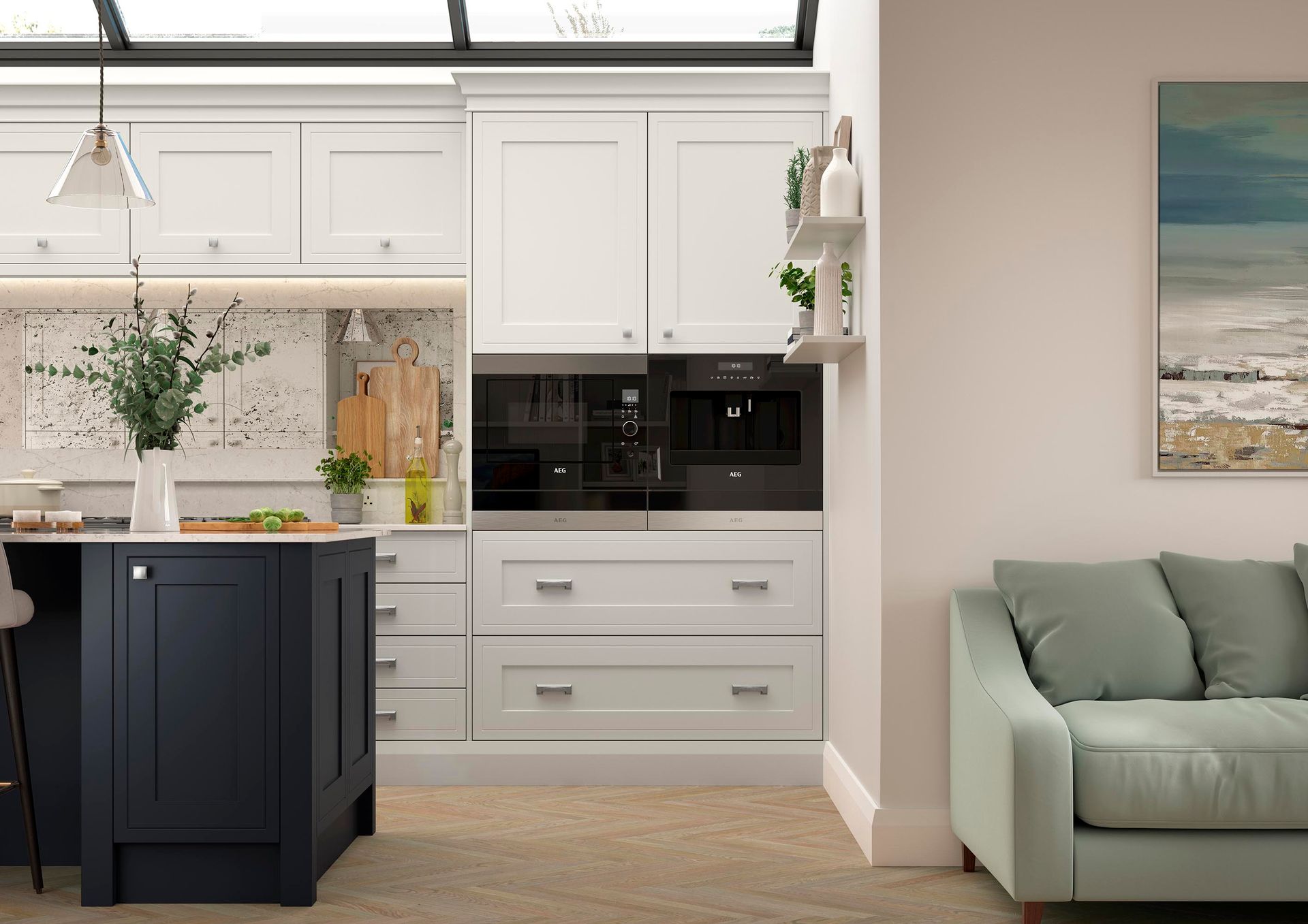 Bright kitchen with white cabinets, dark island, built-in appliances, and a light green sofa nearby