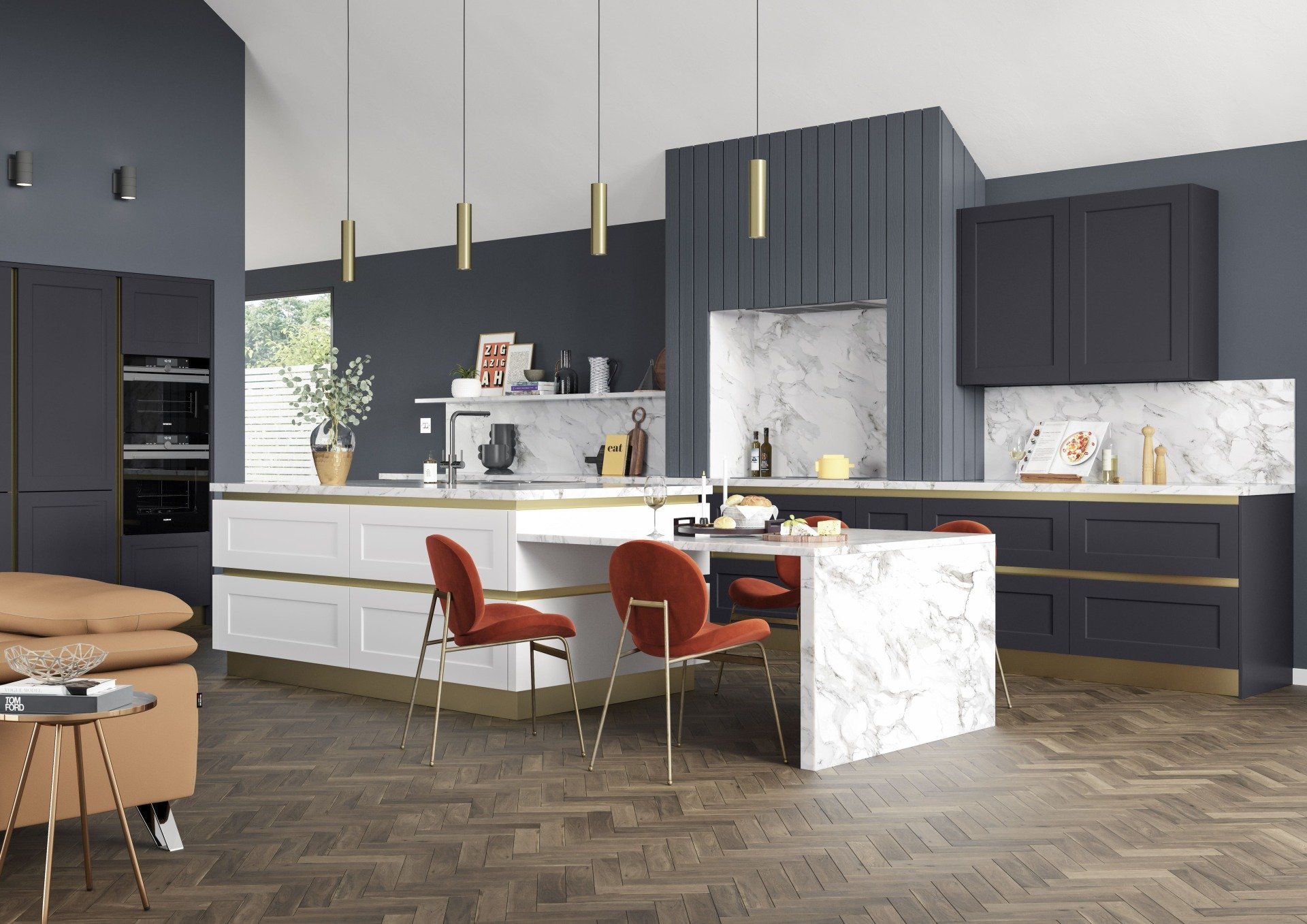 A modern kitchen with dark blue cabinetry, a white marble island with dining space, and orange velvet chairs.