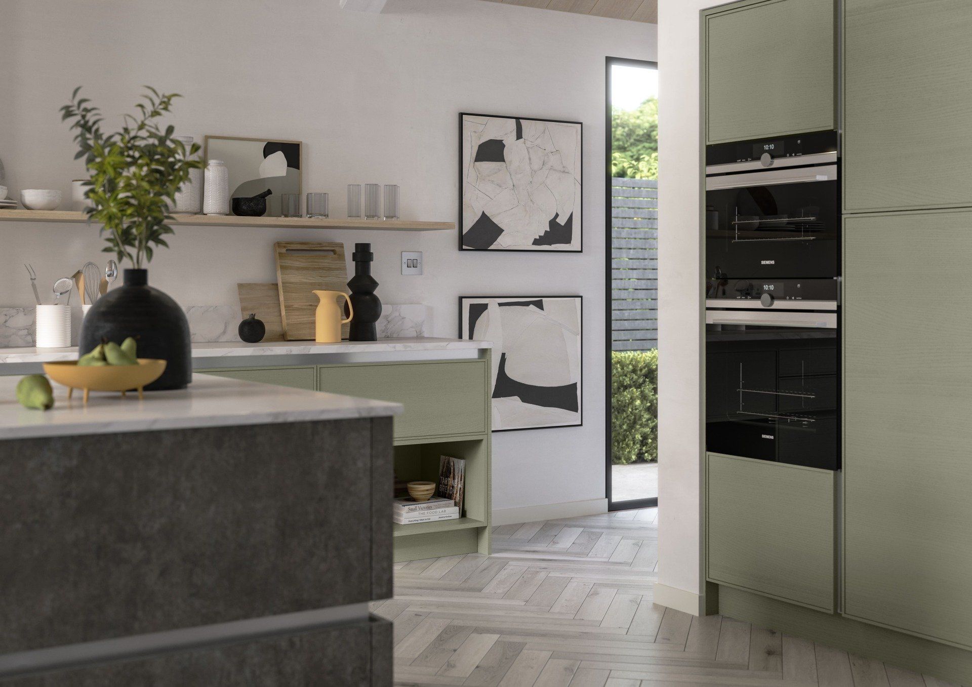 Modern kitchen with sage green cabinets, a dark grey island, herringbone wood floors, and built-in black wall ovens.