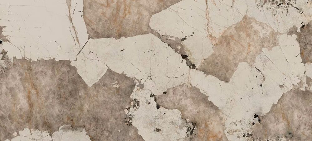A slab of stone with an irregular, geometric pattern of cream-colored veins against textured, brownish-gray rock.