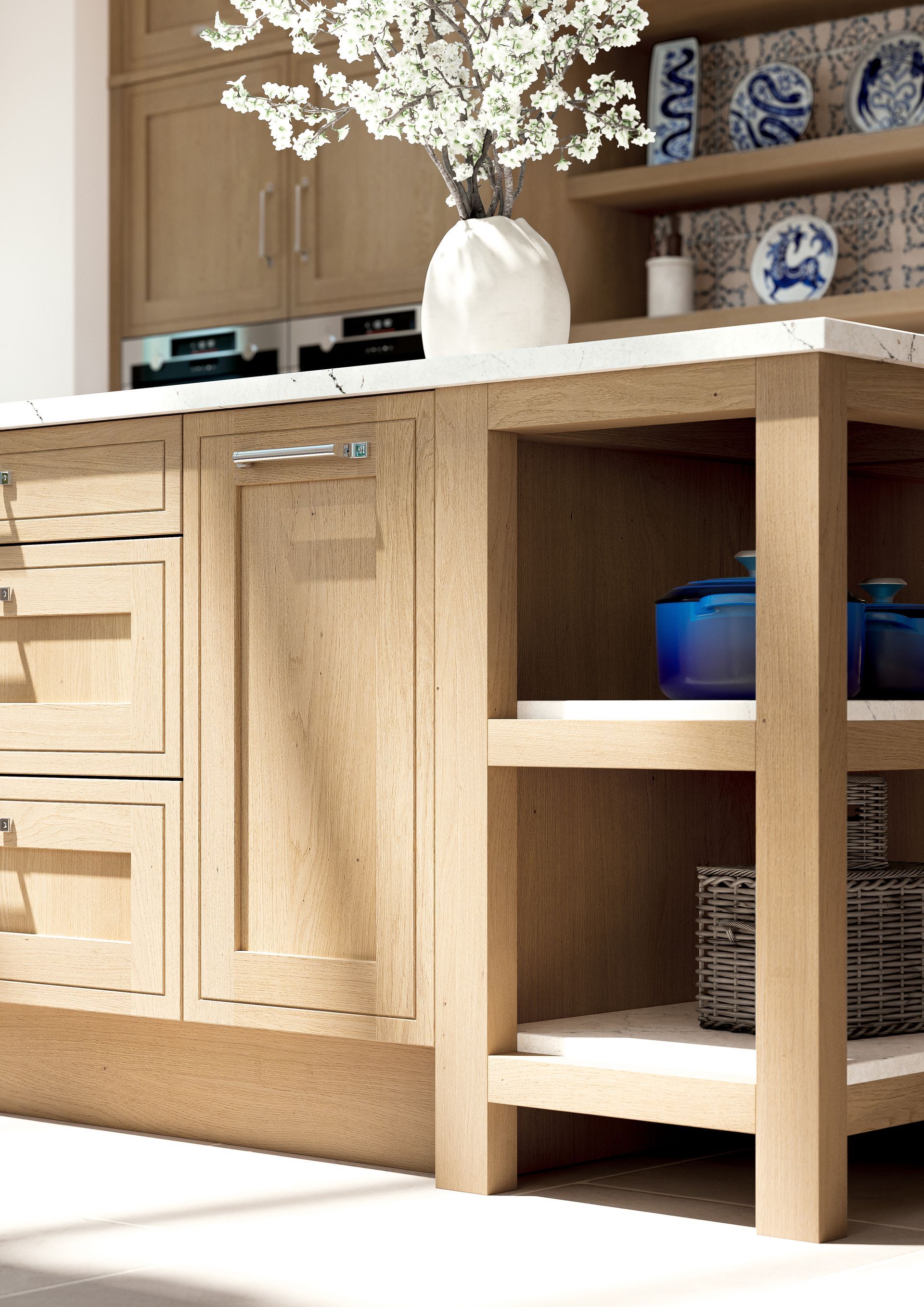 Light-wood kitchen island featuring drawers, a cabinet with a silver handle, and two open shelves holding blue cookware.