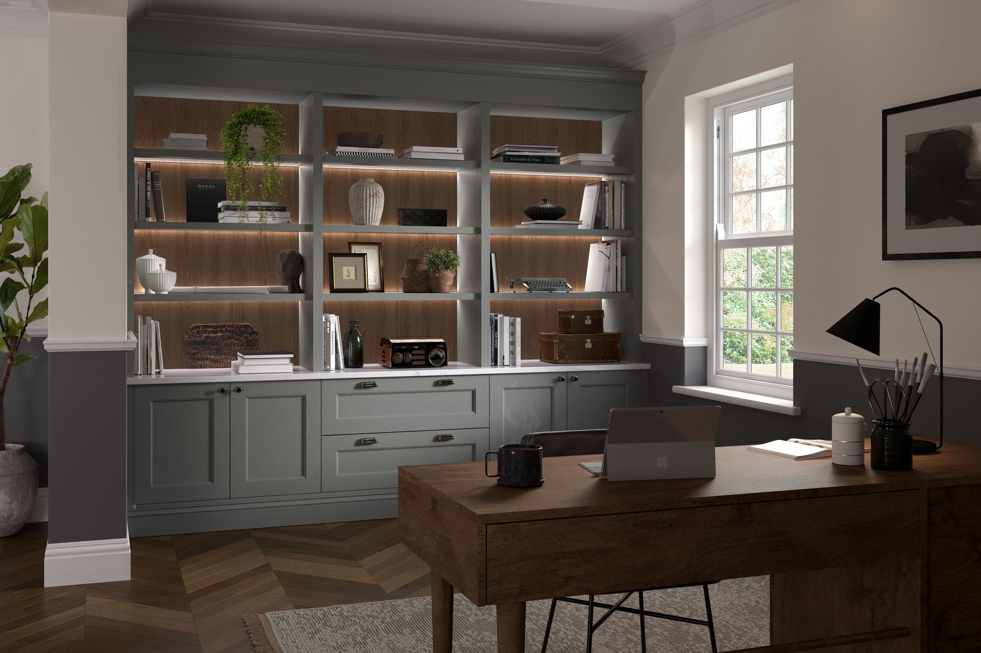 A home office featuring a gray built-in bookshelf with integrated lighting, a wooden desk, and a herringbone floor.