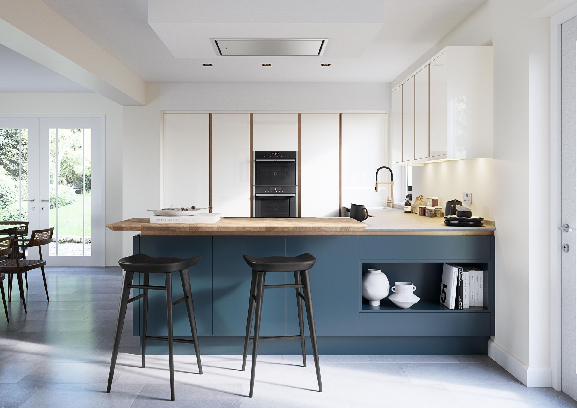 Modern kitchen with a blue island, wooden countertop, two black bar stools, and white cabinetry in a bright, open room.