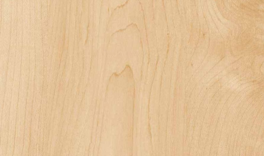 Light-toned wood grain texture with subtle, flowing natural patterns and pale tan swirls.