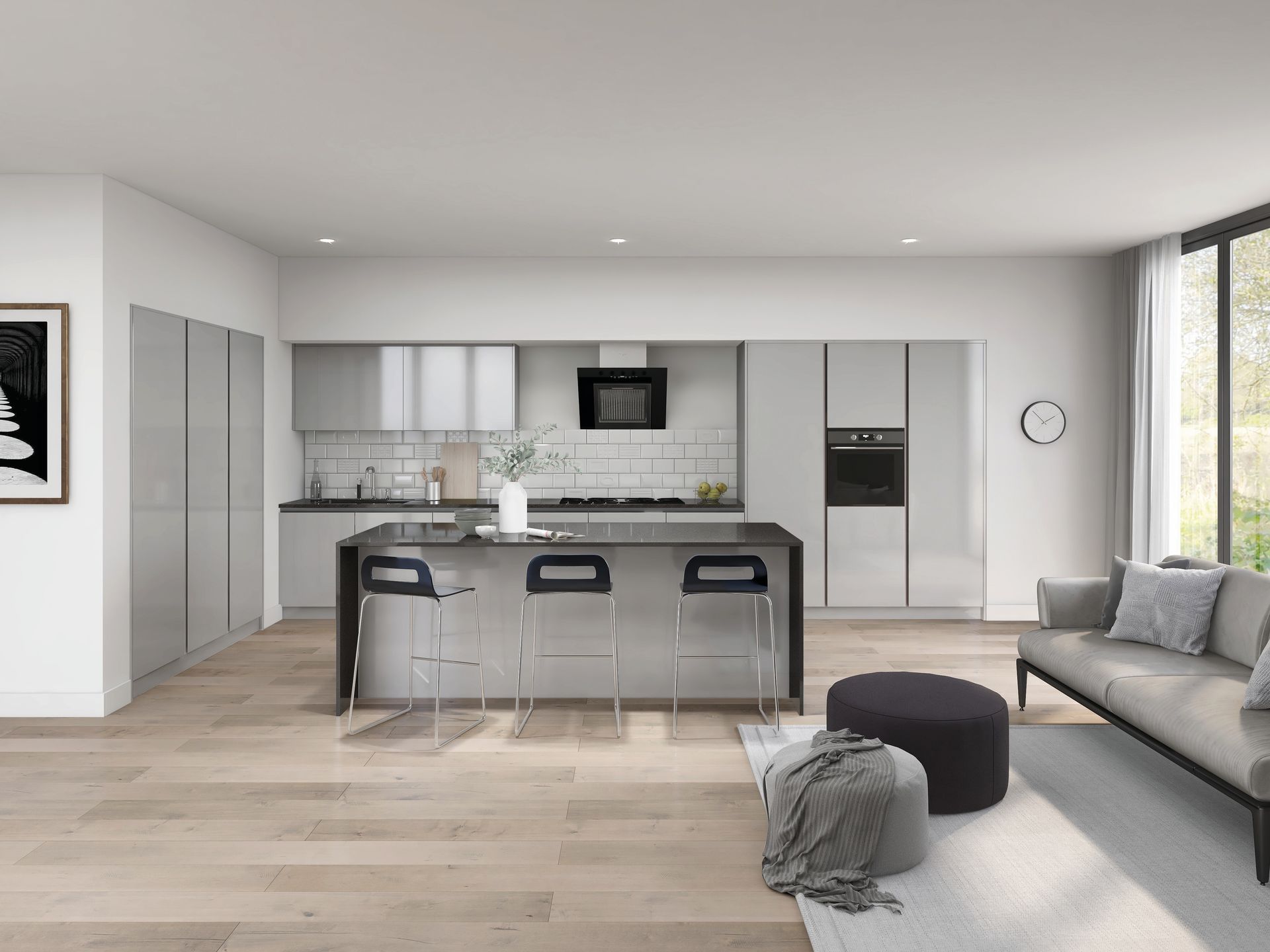 A modern open-plan apartment featuring a light gray kitchen with a central island and a beige sofa in the lounge area.