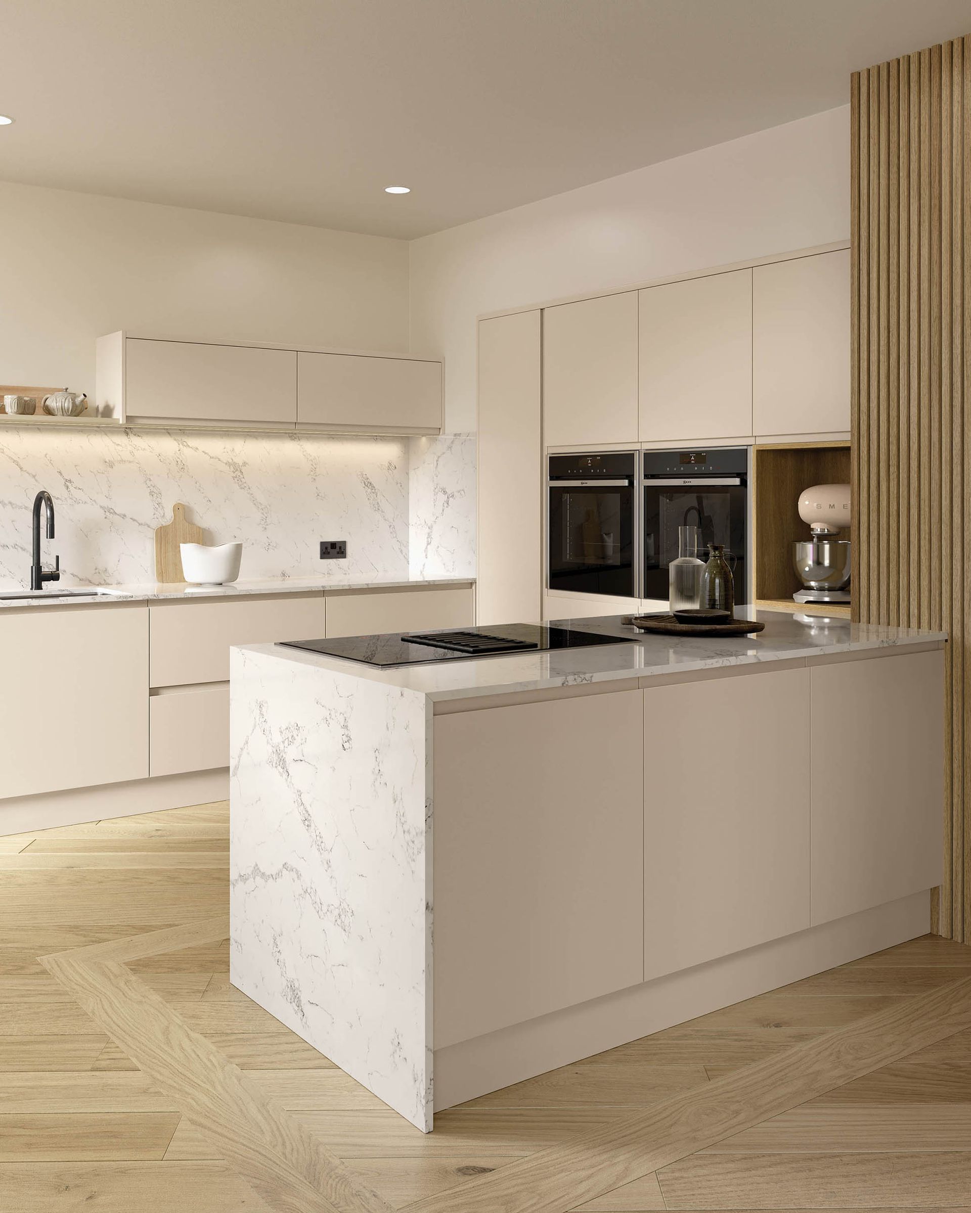Modern kitchen with cream cabinets, white marble countertops, and a herringbone wood floor, featuring a central island.