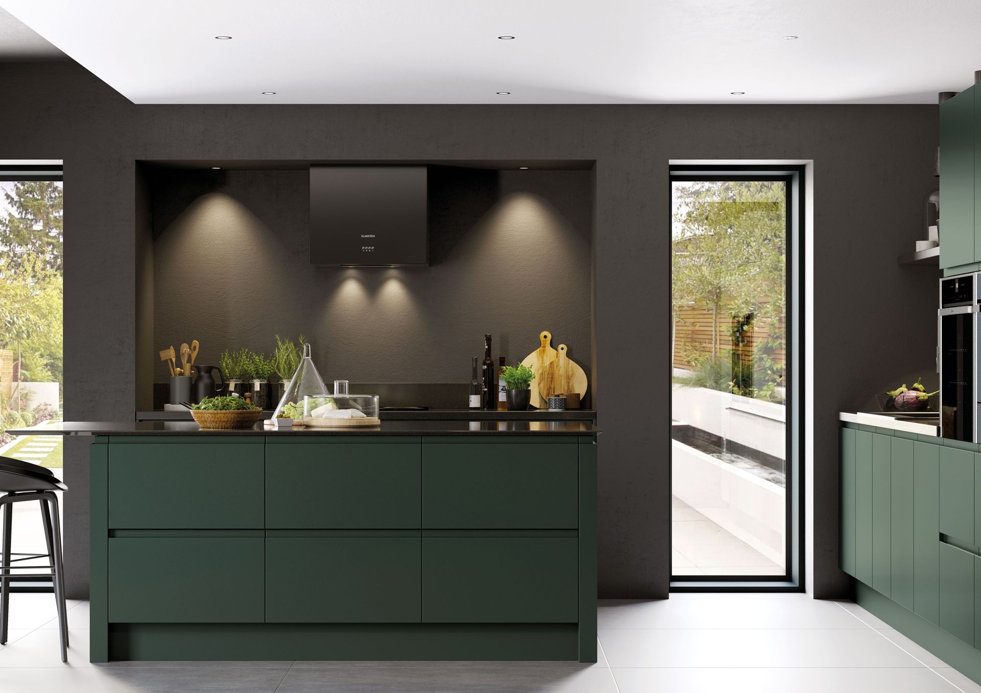 A modern kitchen featuring dark green cabinetry, a central island, and a dark wall with integrated lighting.