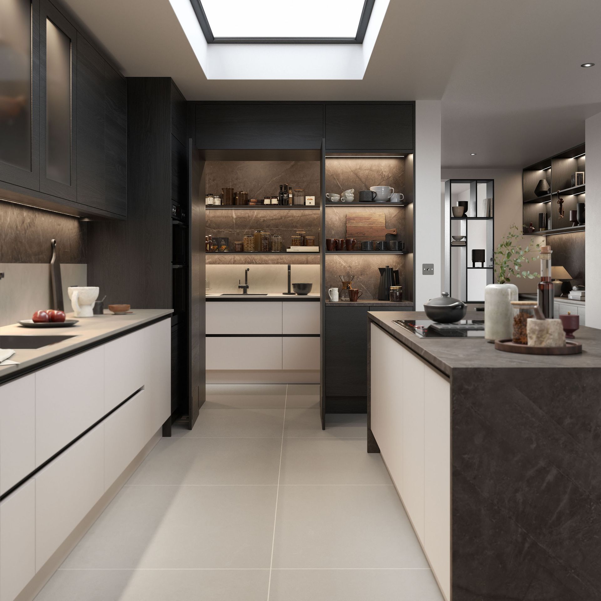 A modern kitchen with dark cabinetry, light-colored countertops, a large central island, and a built-in pantry area.