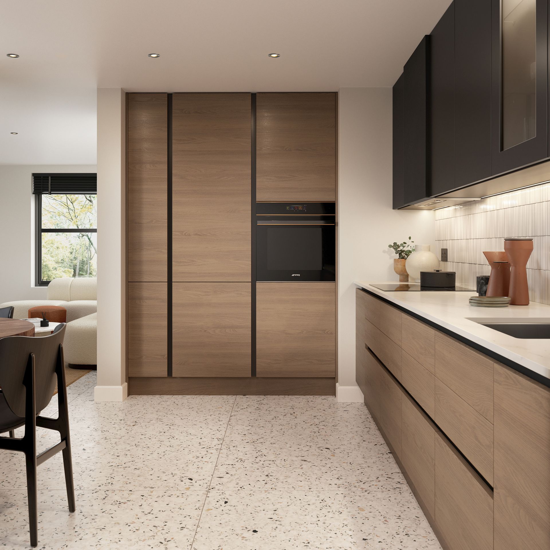 A modern kitchen features light wood cabinets, black upper cupboards, white countertops, and a speckled terrazzo floor.