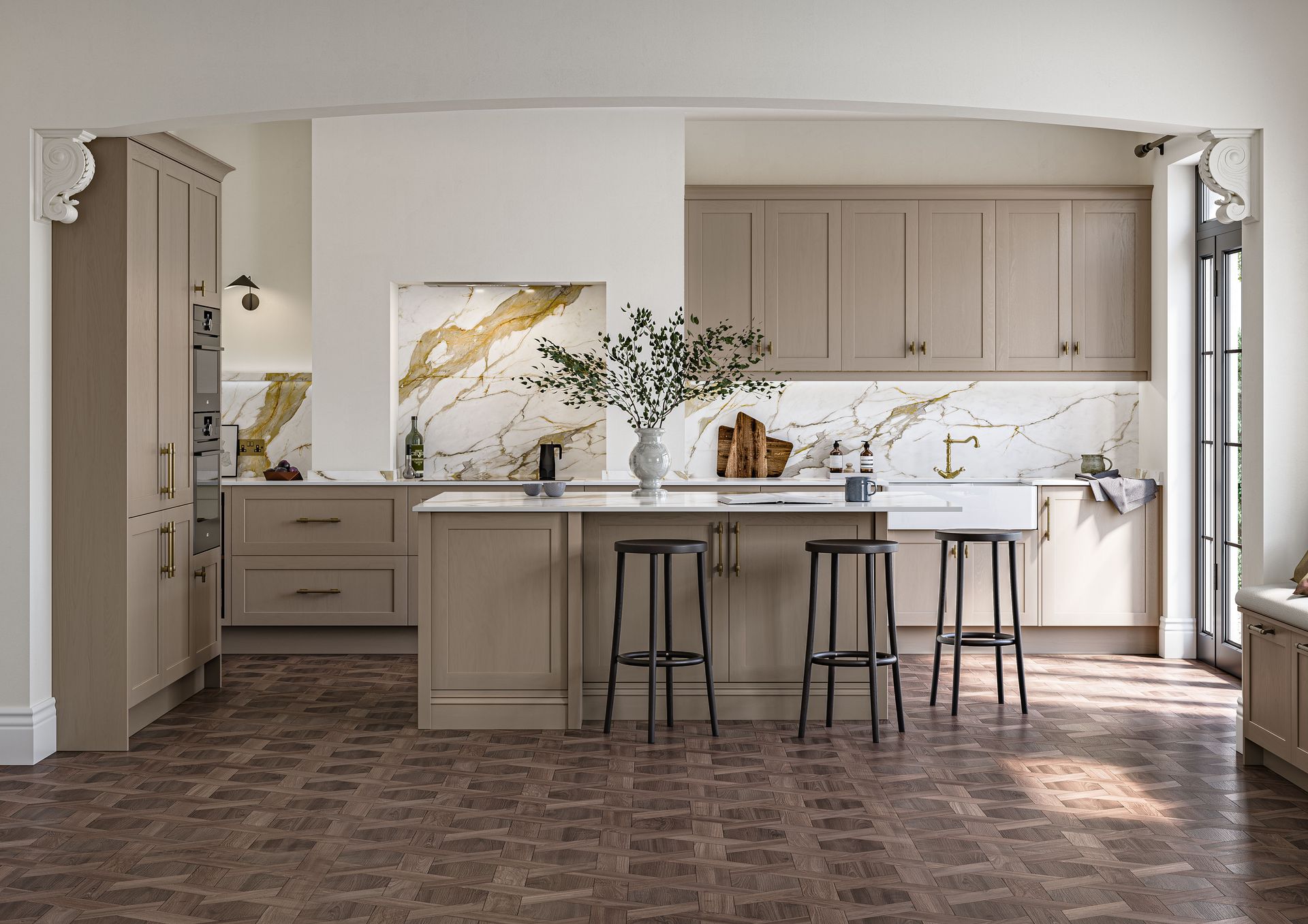 A kitchen with taupe cabinets, a marble backsplash, and a central island with three stools on a dark patterned floor.