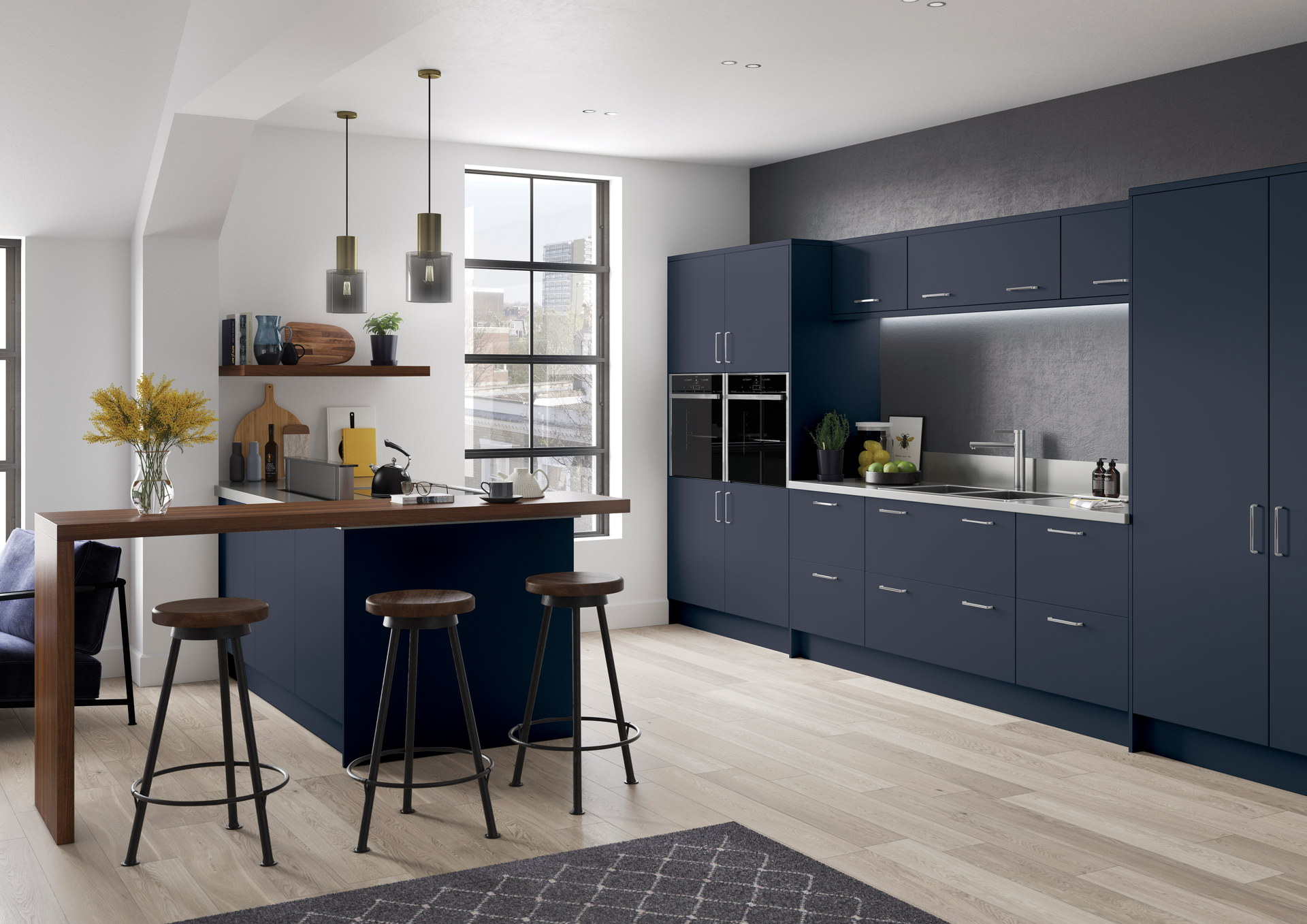 A modern kitchen featuring navy blue cabinets, a wooden breakfast bar with three stools, and light wood flooring.