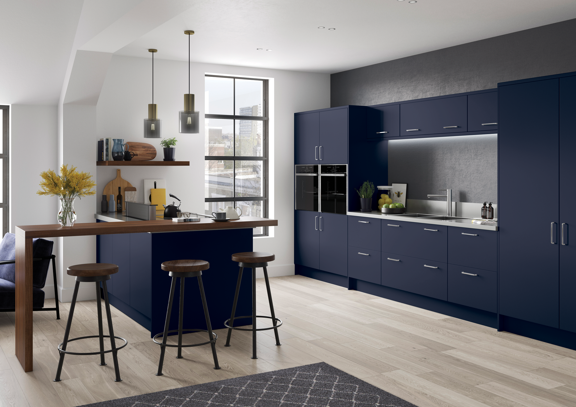 Modern kitchen with dark blue cabinets, a wooden breakfast bar with three stools, and light wood flooring.