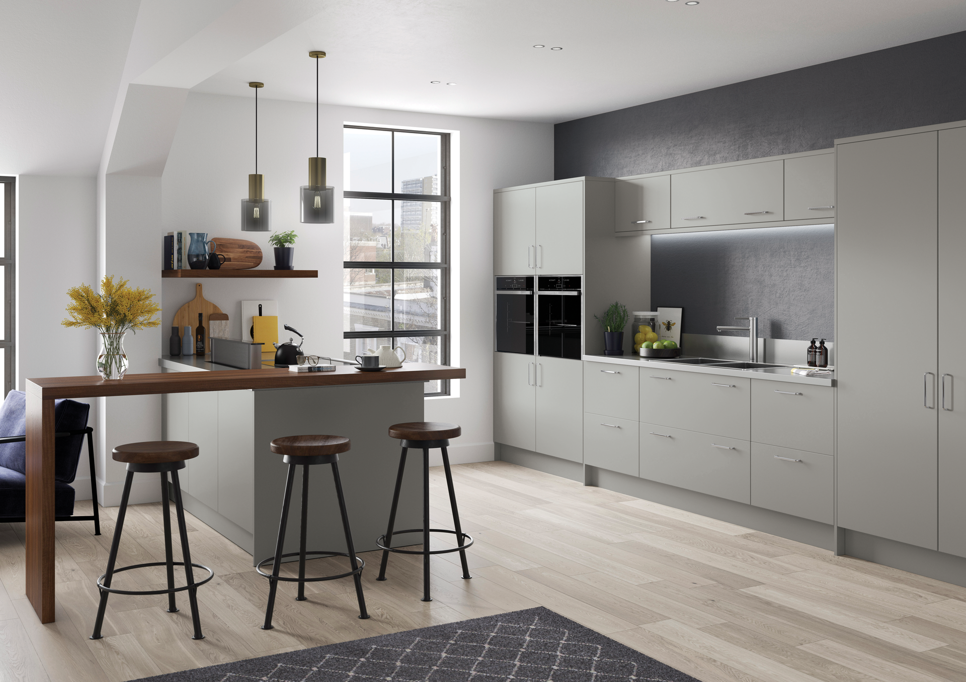 Modern, light-gray kitchen with a wooden breakfast bar, three stools, and a large window in a minimalist urban loft.