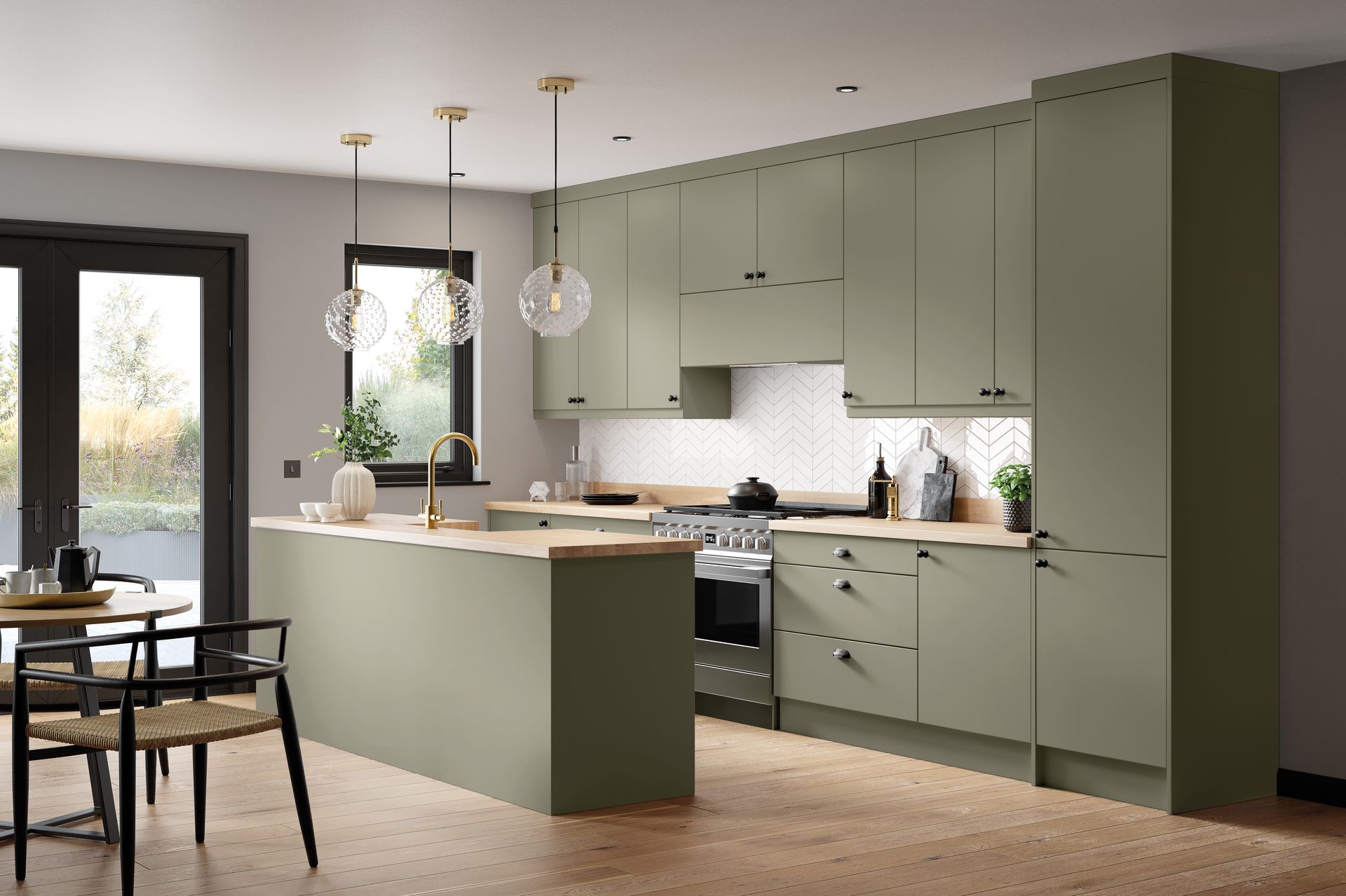 A modern kitchen featuring sage green cabinets, light wood countertops, glass pendant lights, and a dining area.